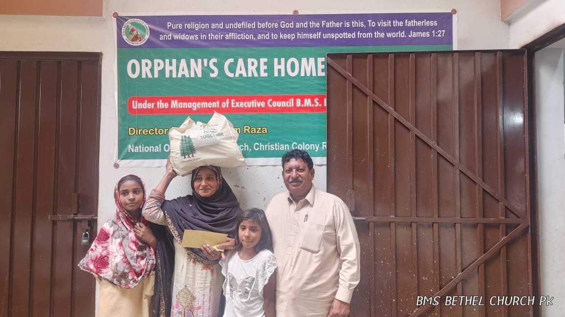 Widow Zarina receives food aid with a smile on her face.