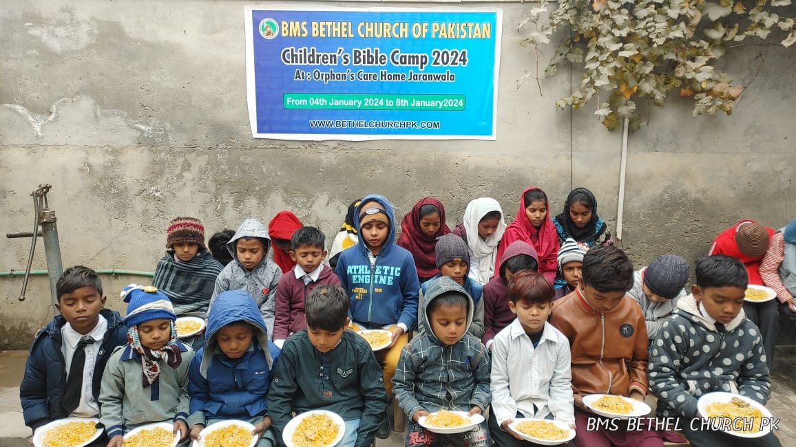 Kids are taking lunch in the Bible Camp.