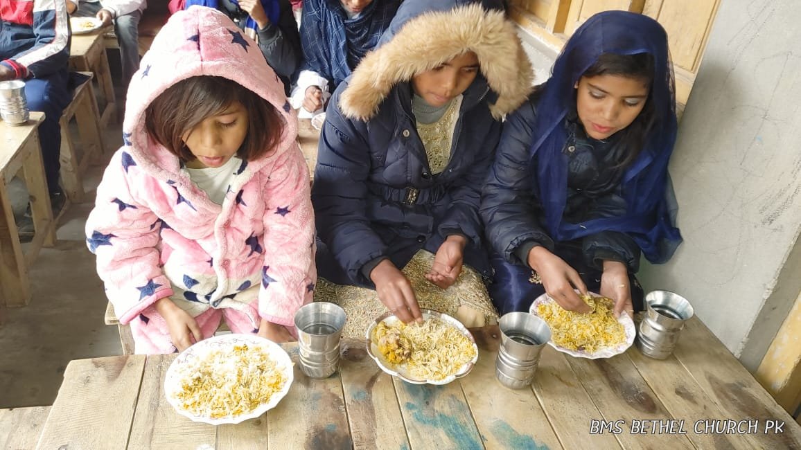 Little girls are taking Lunch in the Bible Camp.