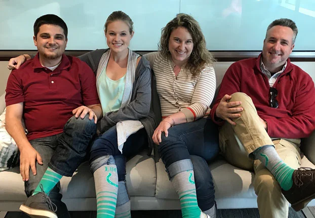 Charlotte (second from left) brought "lucky socks" for everyone to wear on embryo transfer day!