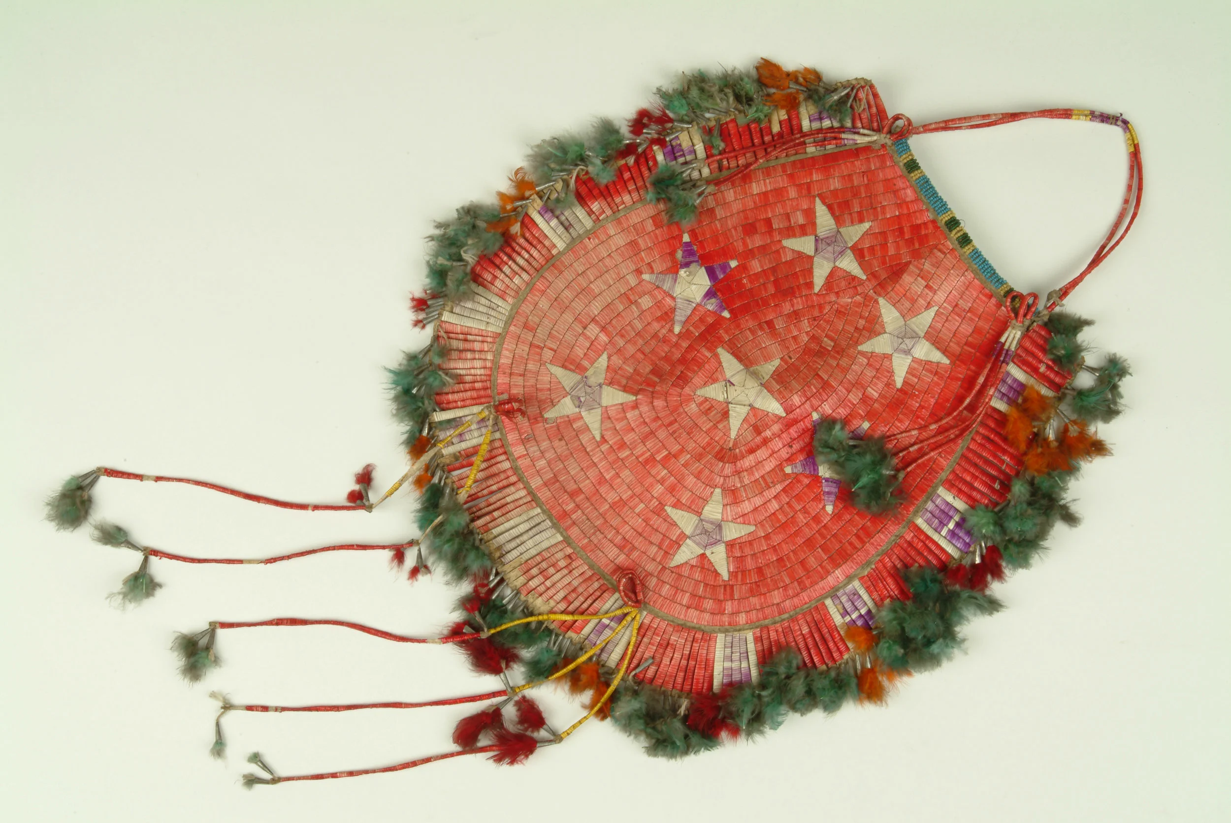 Quilled Bag from the Duhamel Collection. This large bag as an unusual row and star pattern and is trimmed with several drops, metal cones and tassels. Pine Ridge Reservation, circa 1900.