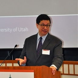 jc-at-podium-with-patent-pledges-on-screen.jpg