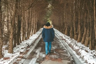 man walking in woods with sonw-min.jpg