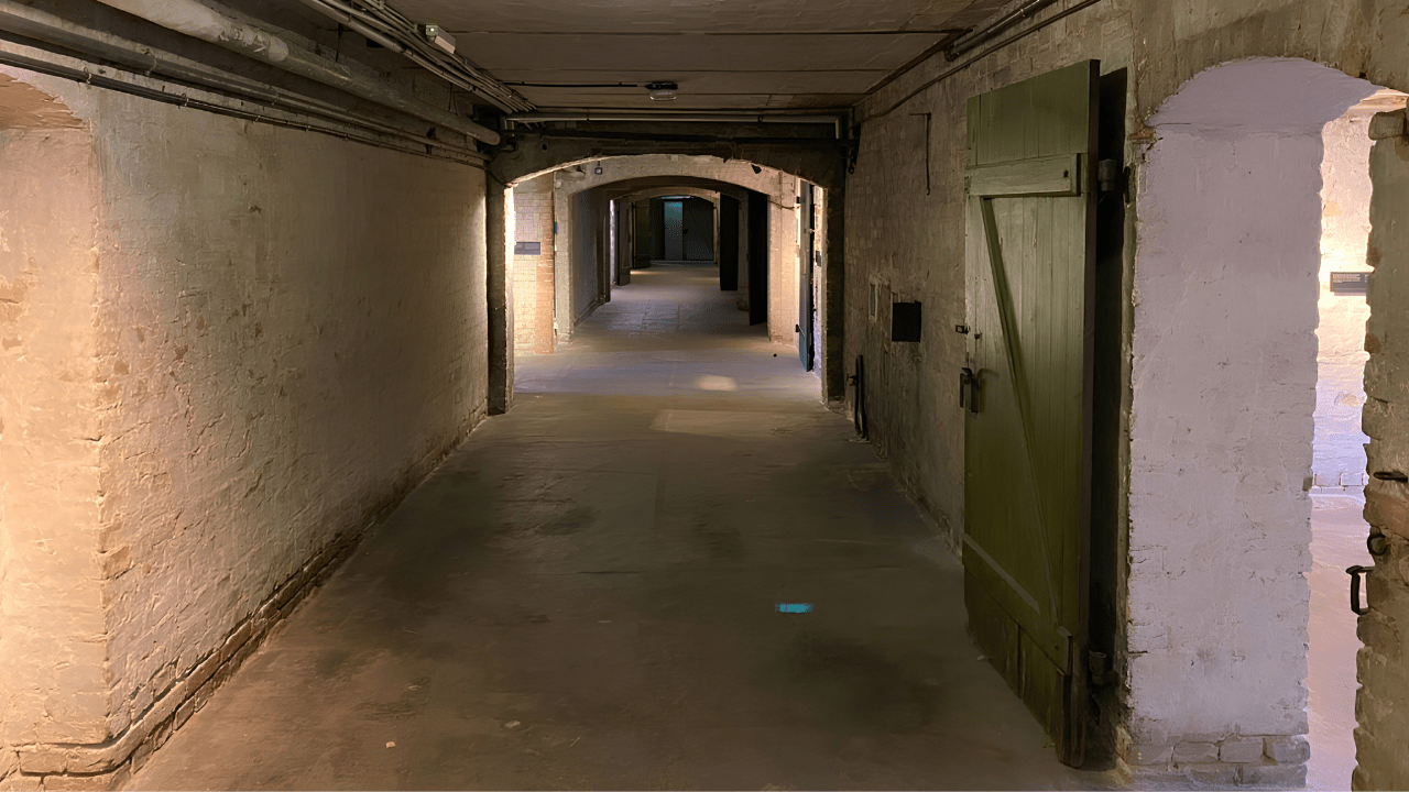 Interior corridor of a hidden WWII bunker in Berlin, showcasing the underground infrastructure built to protect civilians and military personnel during Allied bombing raids.