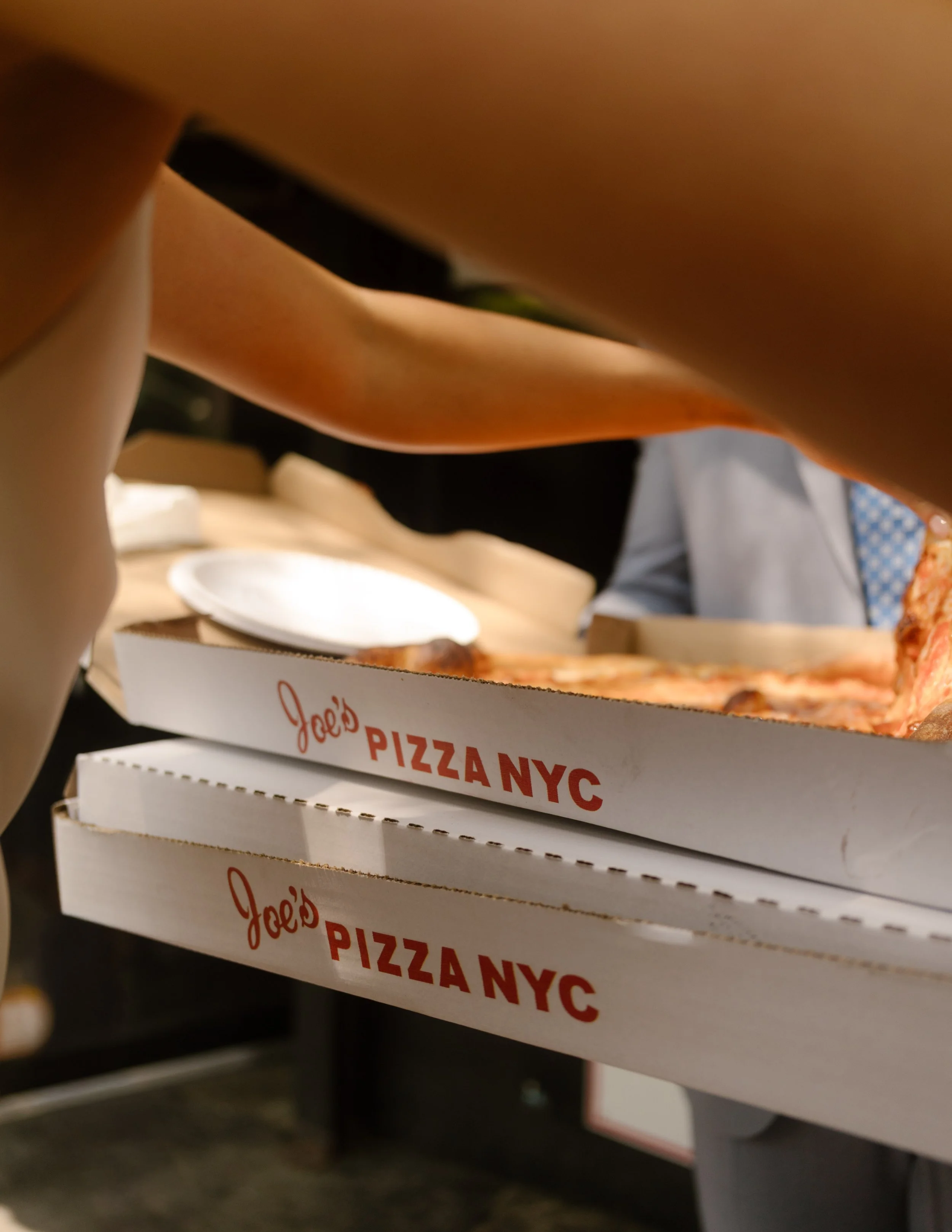 Stacked Joe’s Pizza boxes being carried out—because no New York City elopement is complete without a post-vow slice.