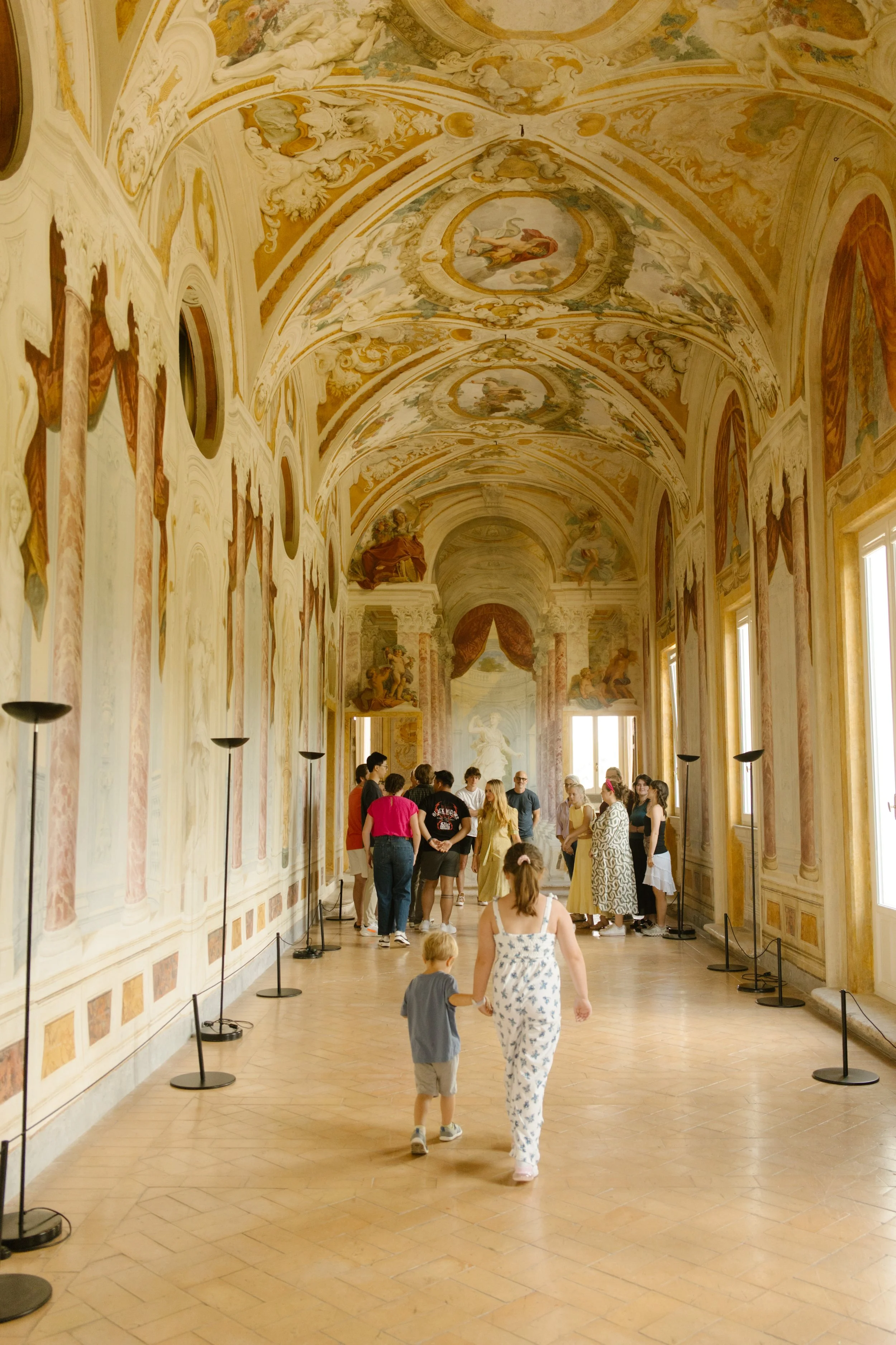 Family walking through ancient museum in Italy.