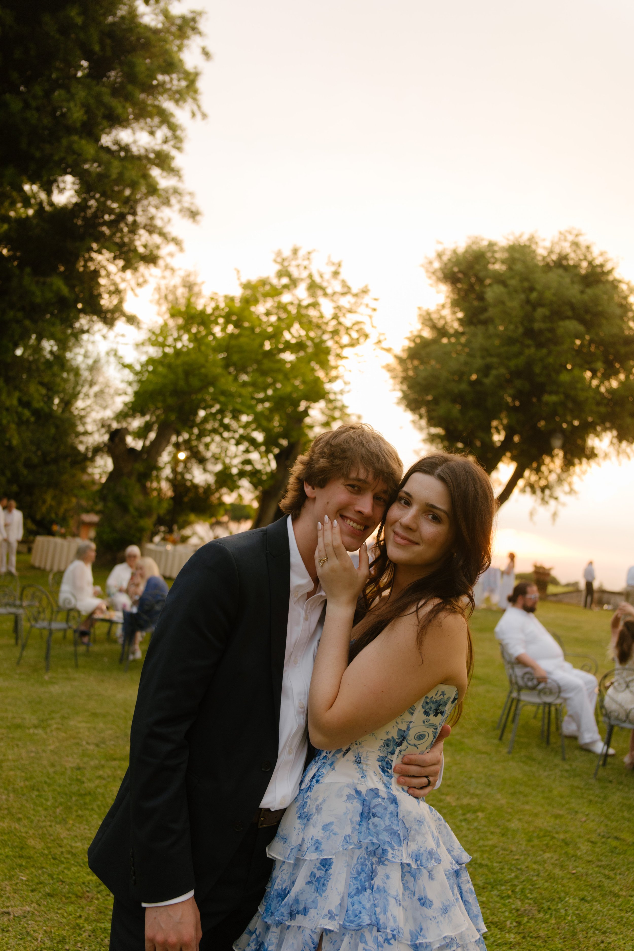 Bride and groom embrace smiling and cuddling sweetly. 