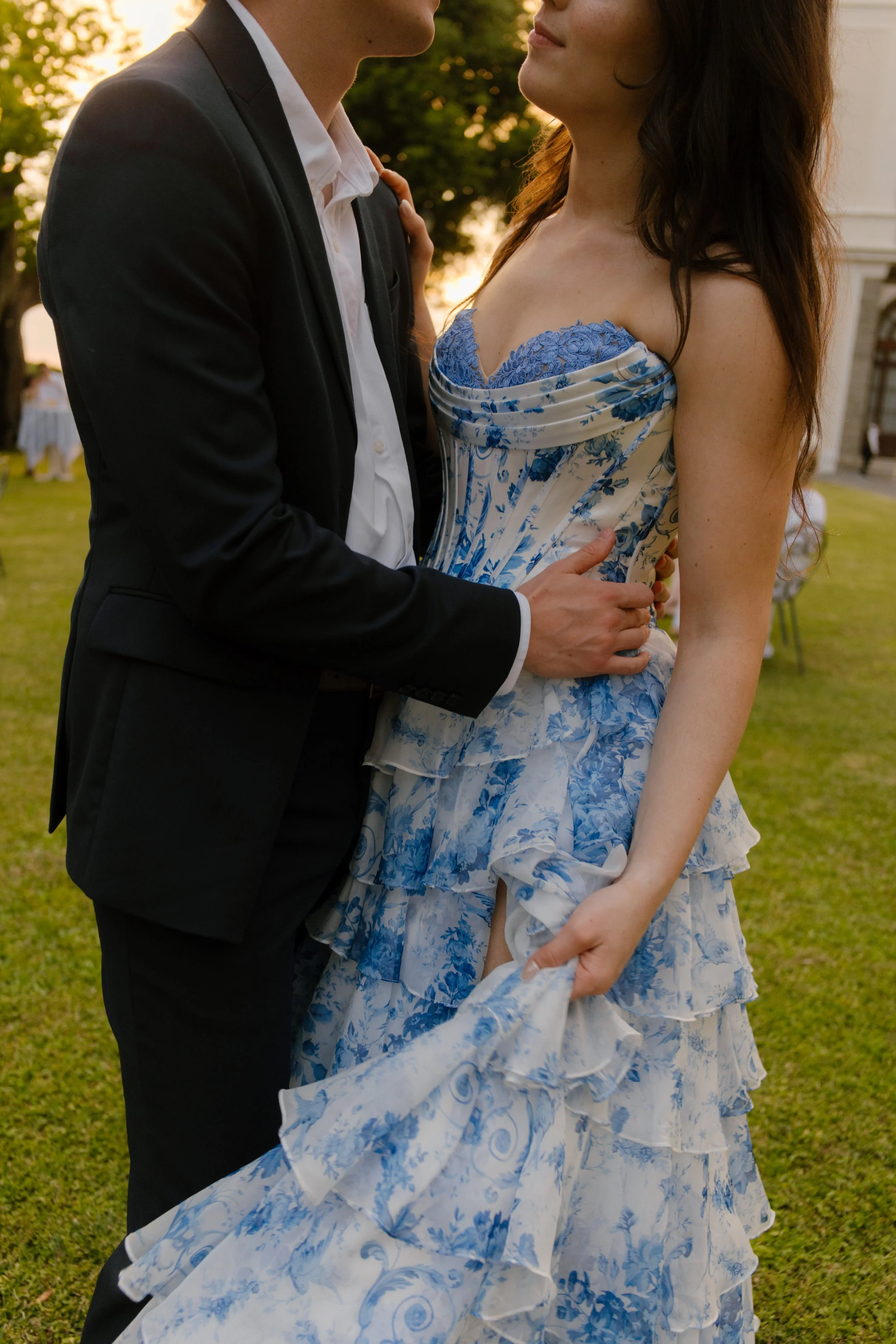 Groom holding bride closely while wearing suit and bride in her blue wedding dress. 