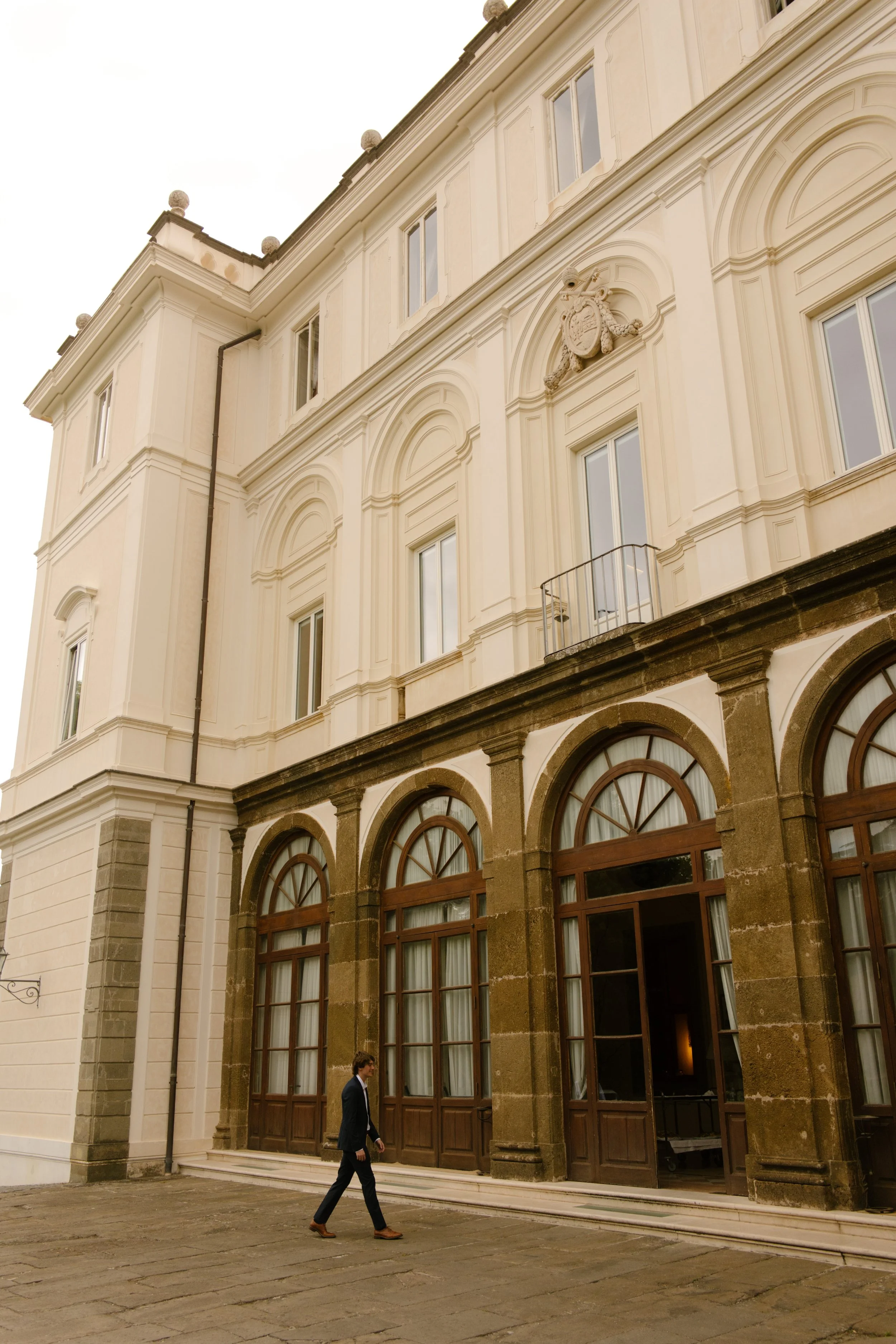Wedding guest walking outside of Italian building during week long exploration. 