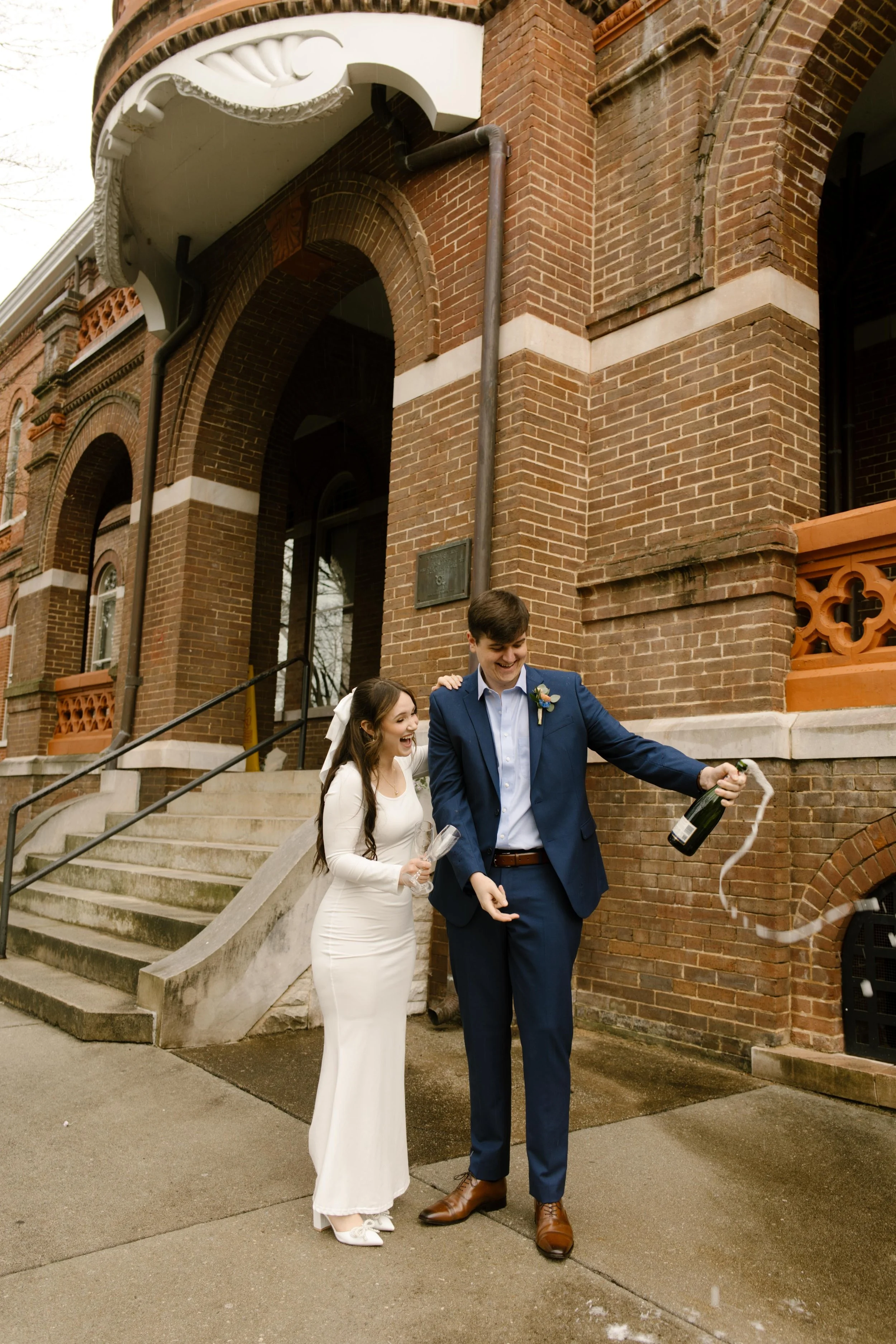 Framed by arches and checkerboard tile, the couple gazes out over the city—soaking in their just-married glow after a Knoxville courthouse elopement.