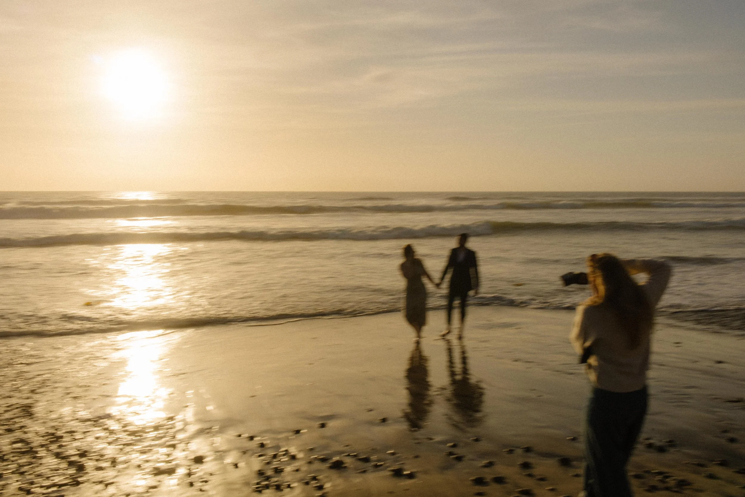 A behind-the-scenes look as a photographer captures golden hour magic during a San Diego engagement photo session.