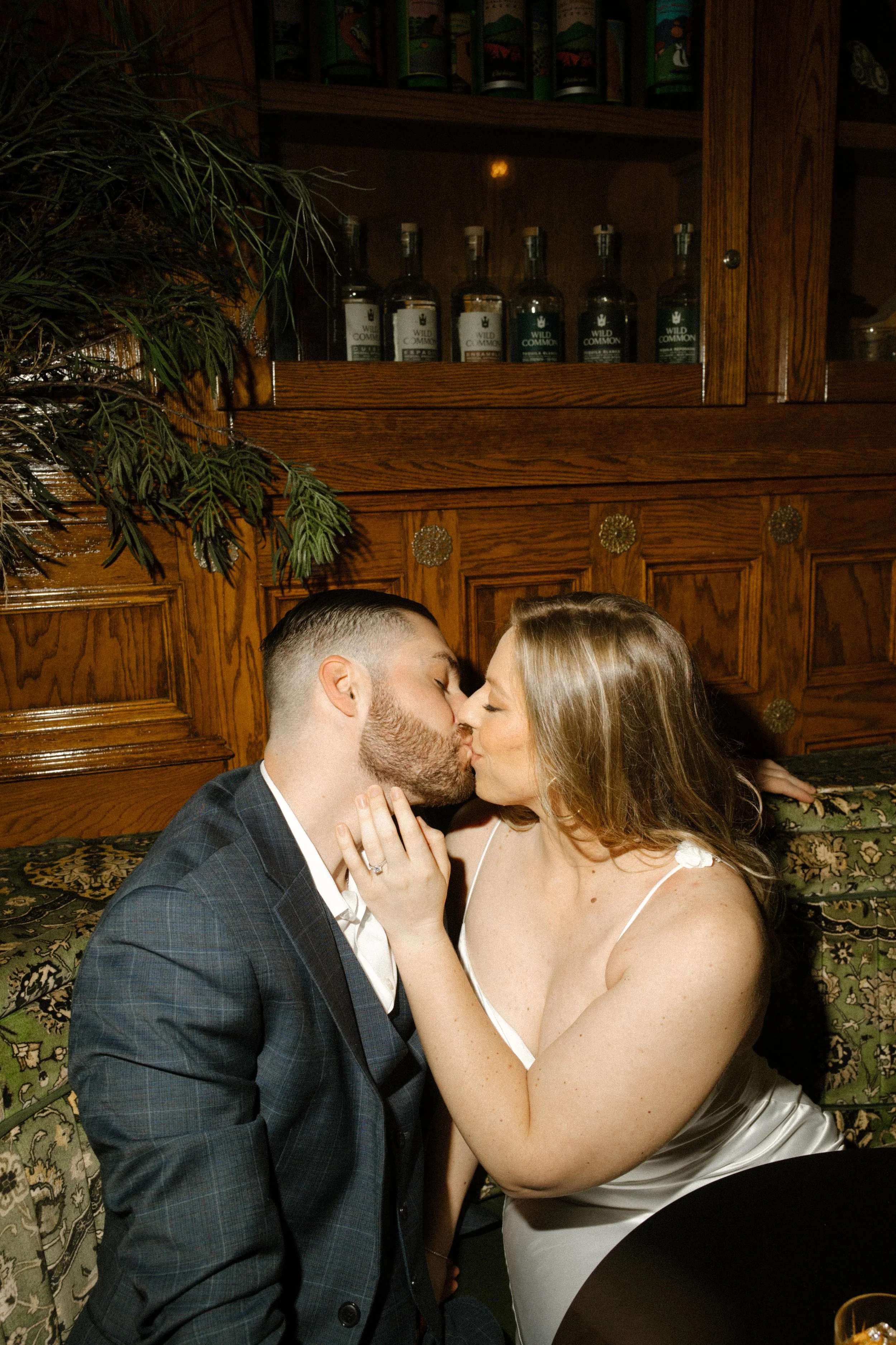 A kiss between cocktails, full of warmth and connection — a favorite frame from their San Diego engagement photos.