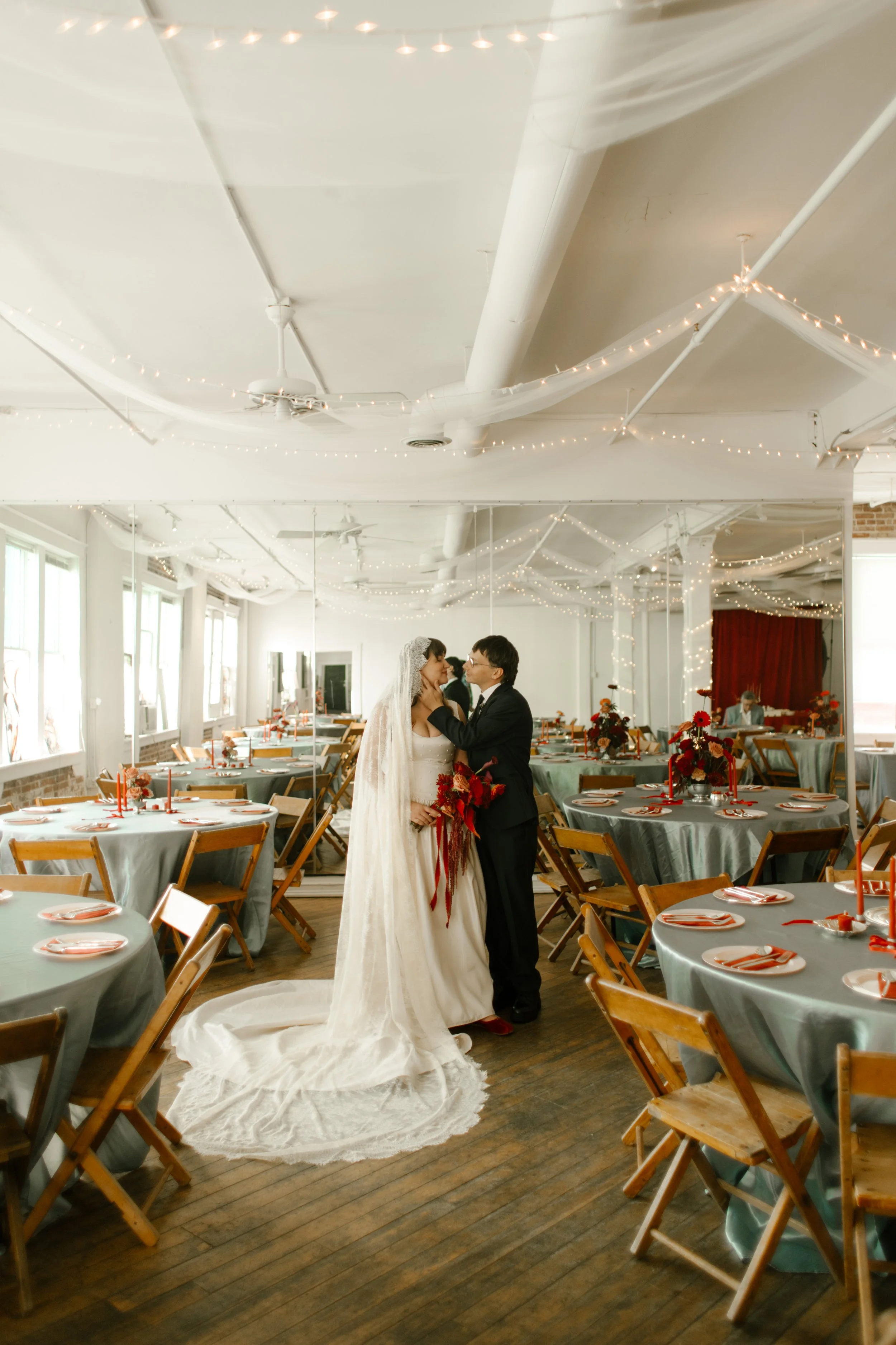 Groom touches bride's cheek while looking at her adoringly during bride and groom photos after their Tennessee wedding