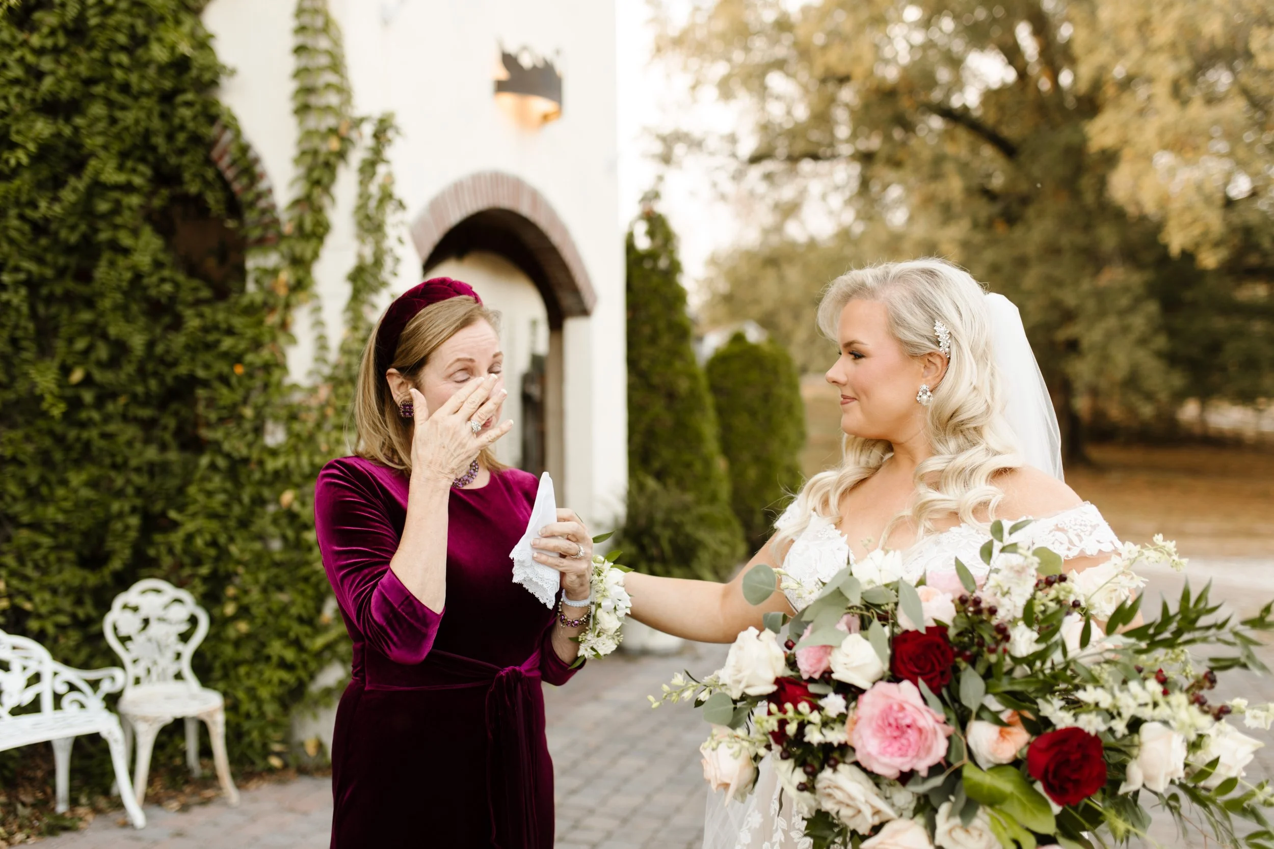 Bride embracing an emotional guest outside the villa during a heartfelt moment at an italy inspired wedding.