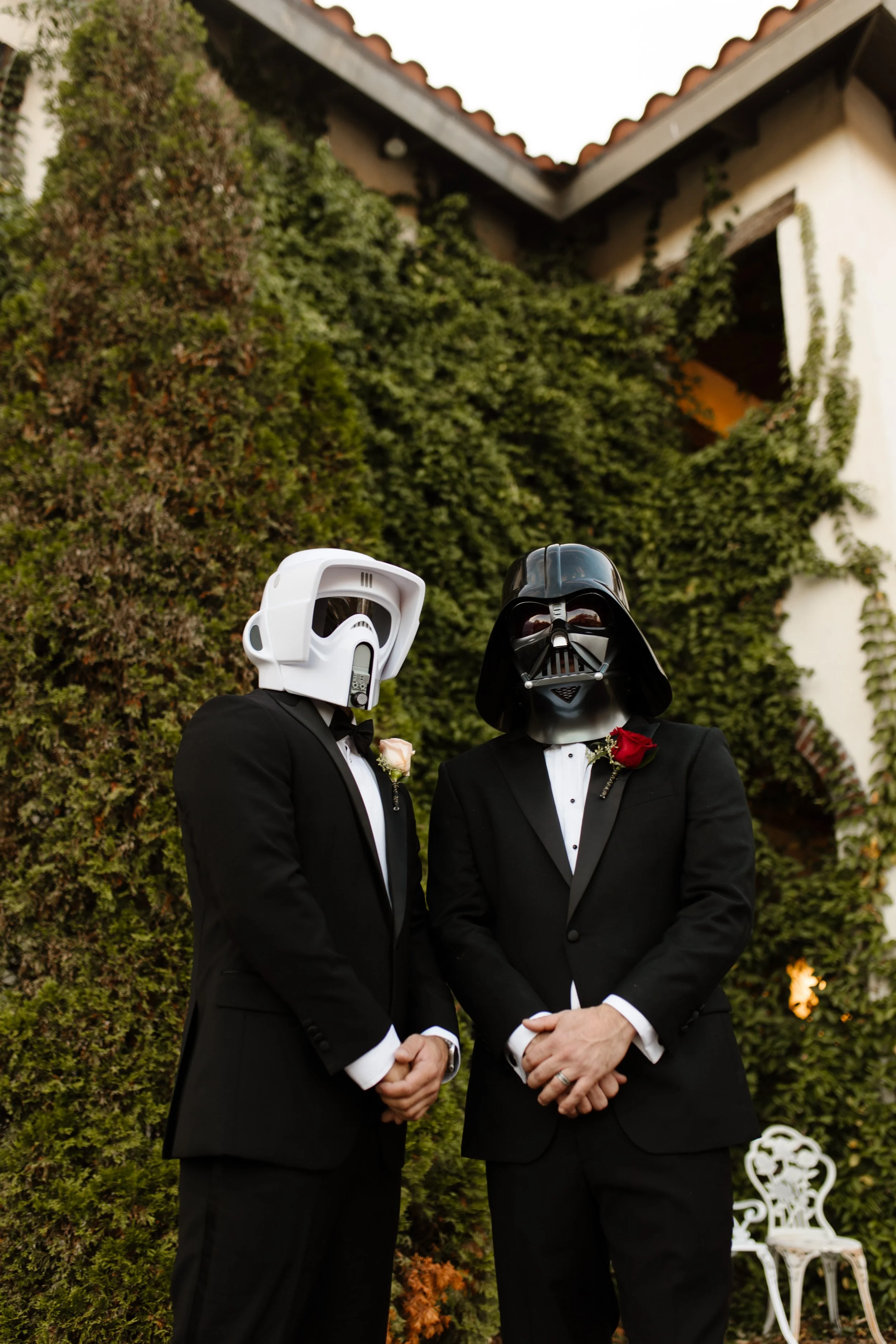 Groomsmen wearing Star Wars helmets in front of an ivy-covered villa during a fun, personality-filled italy inspired wedding celebration.