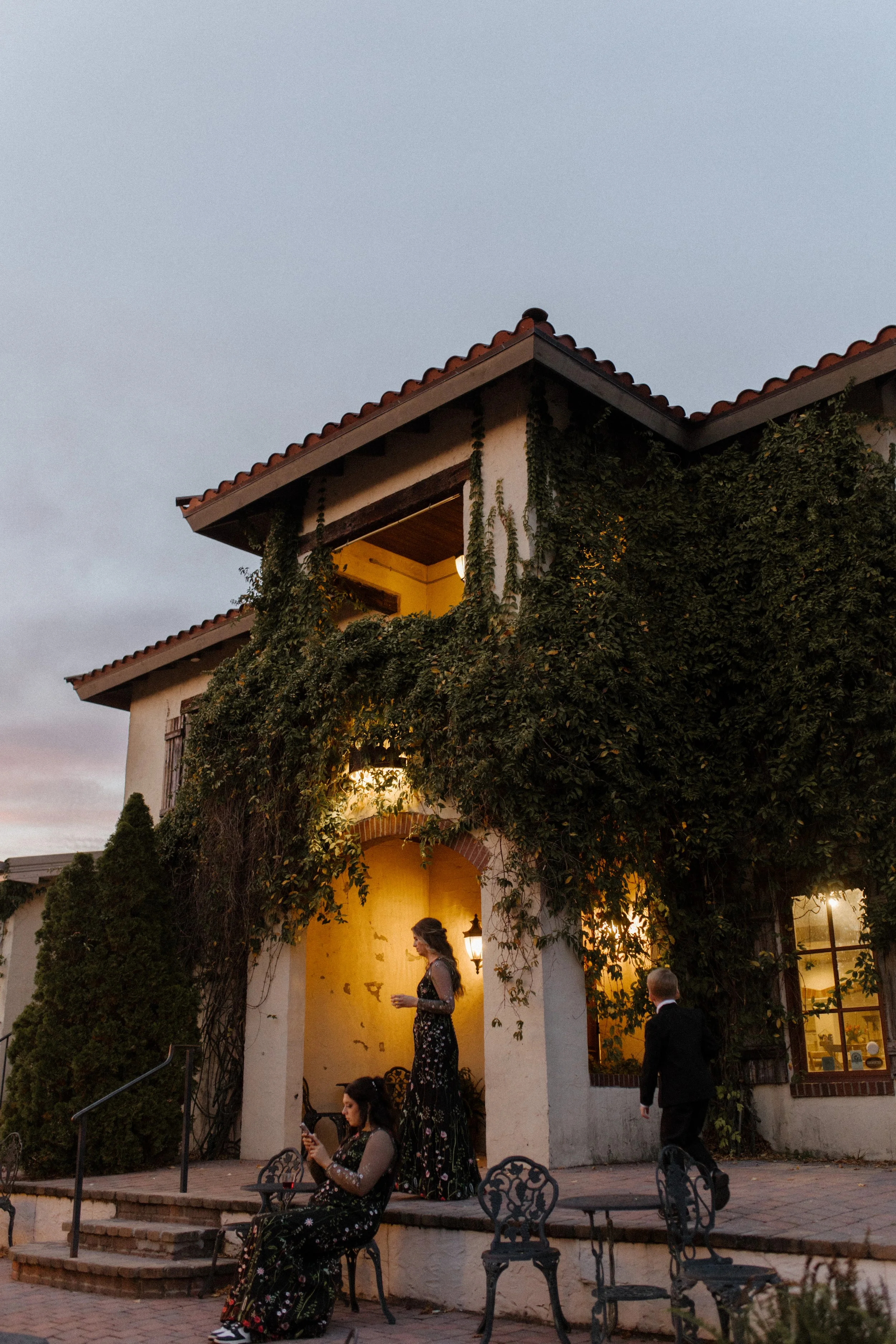 Ivy-covered Mediterranean-style villa glowing at dusk during an elegant italy inspired wedding celebration.