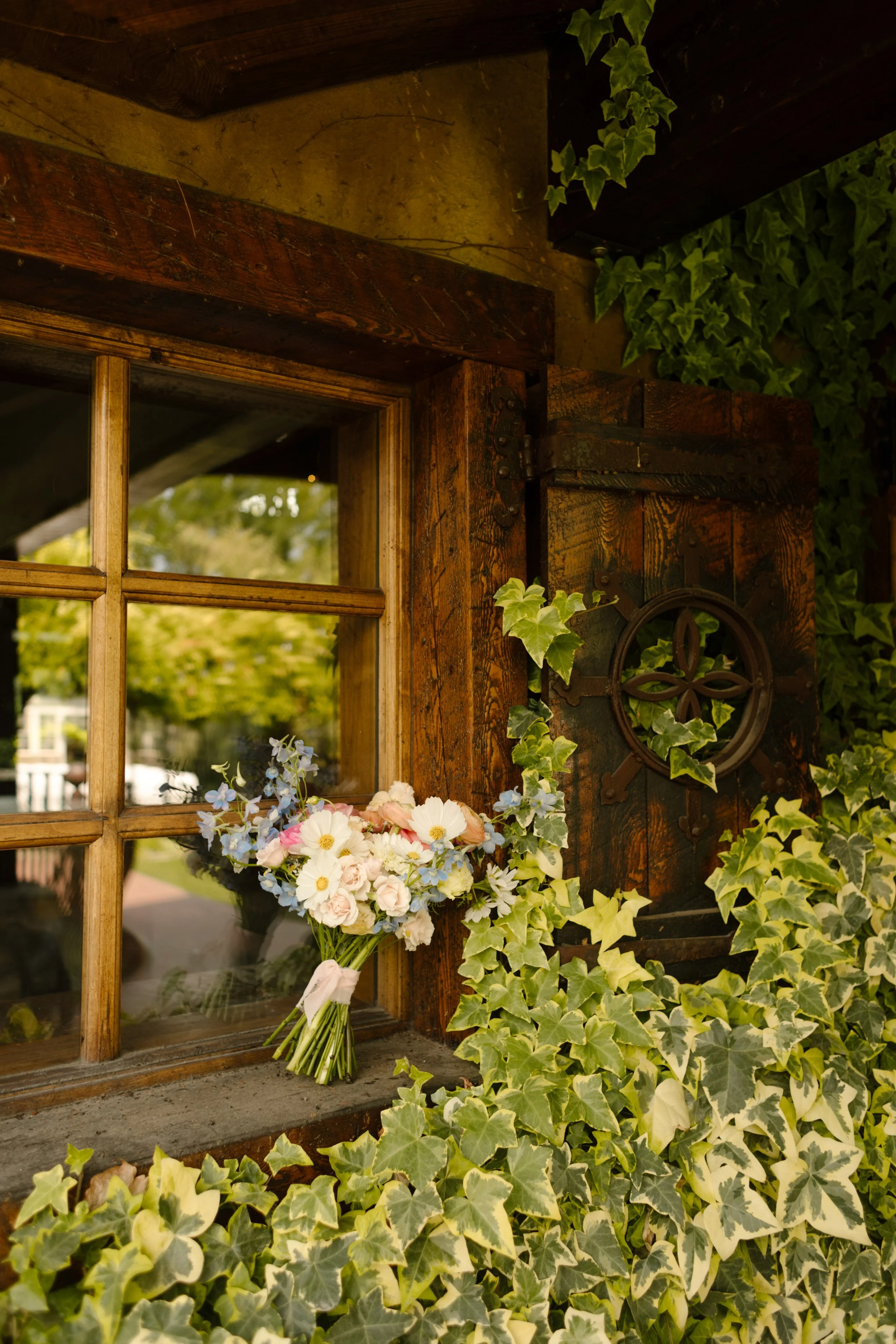 Bridal bouquet sitting on windowsill outside of utah wedding venue