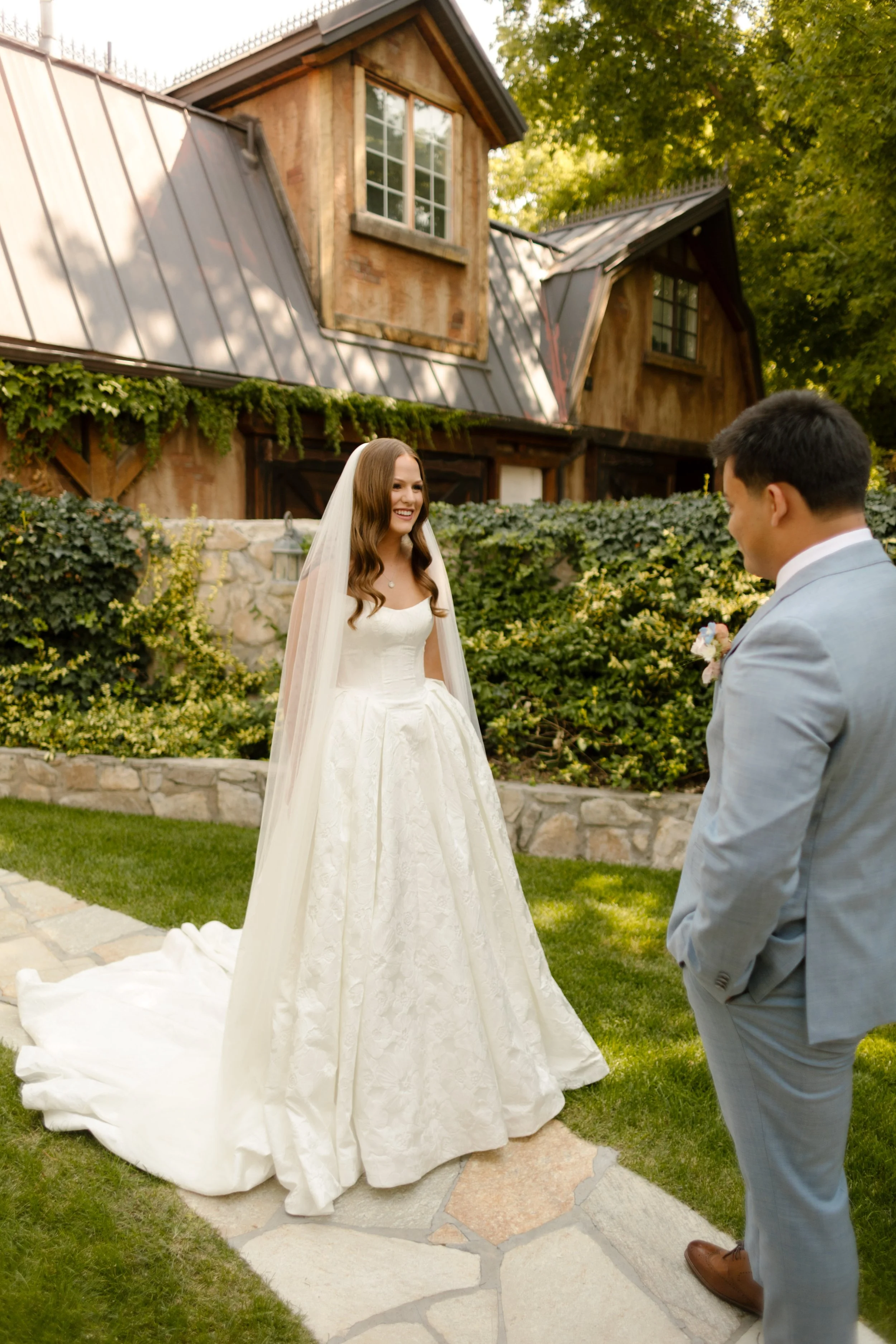 Bride coming out to see groom during first look before ceremony at utah wedding venue