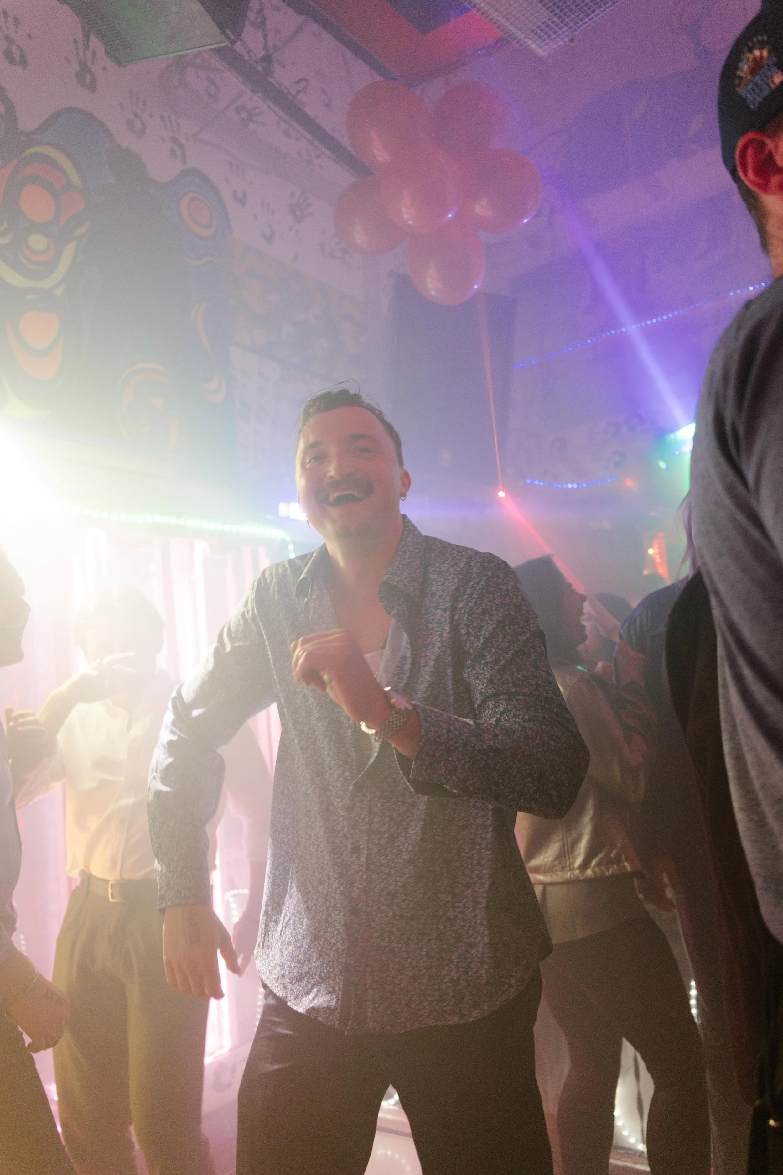 Guest having fun on the dance floor dancing and celebrating bride and groom at wedding after parties.