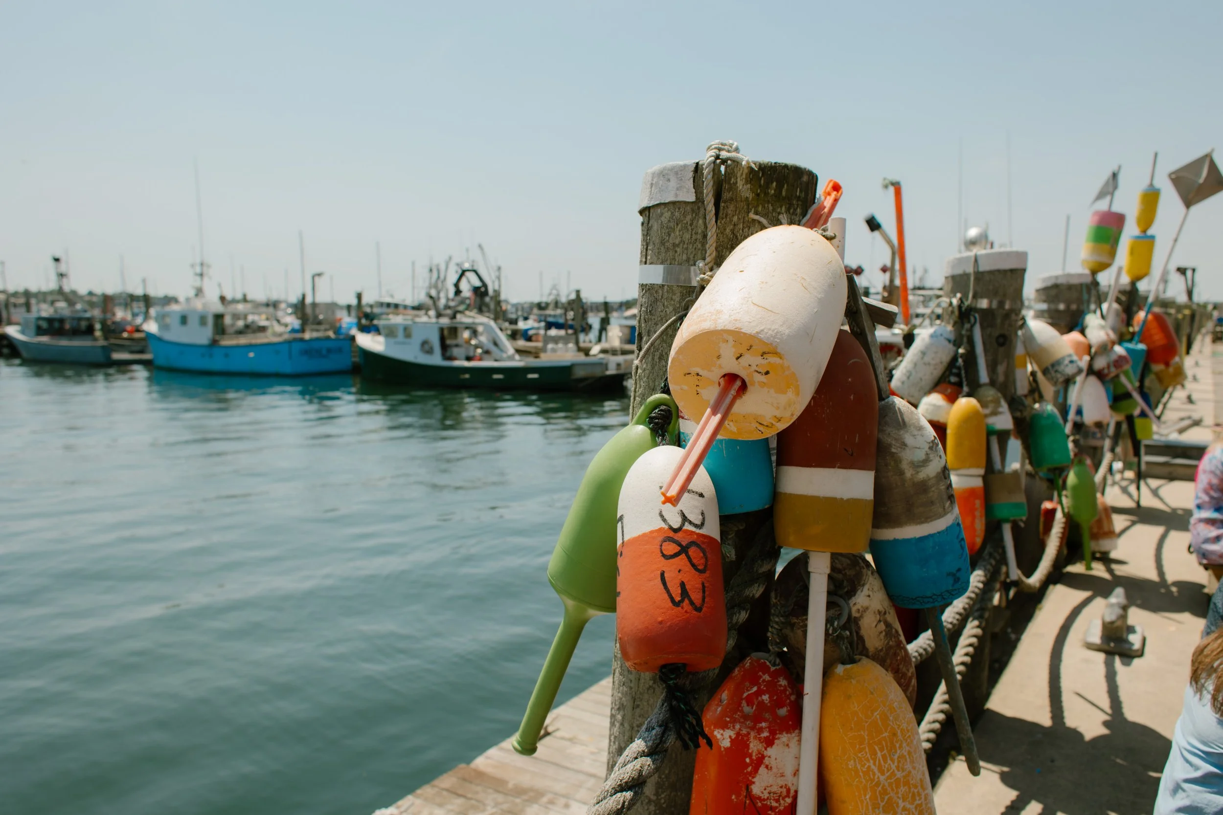 Colorful lobster buoys hanging on Newport harbor dock during Newport Rhode Island engagement photos