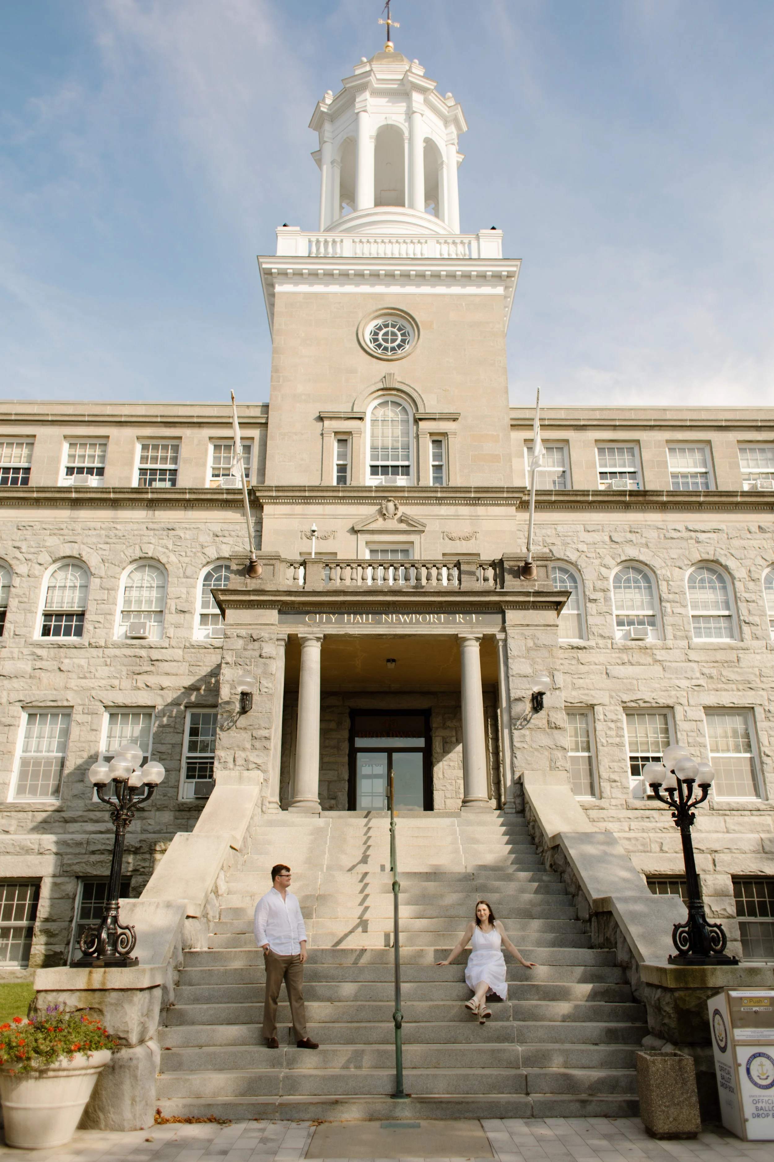 Couple on steps of historic Newport City Hall during Newport Rhode Island engagement photos