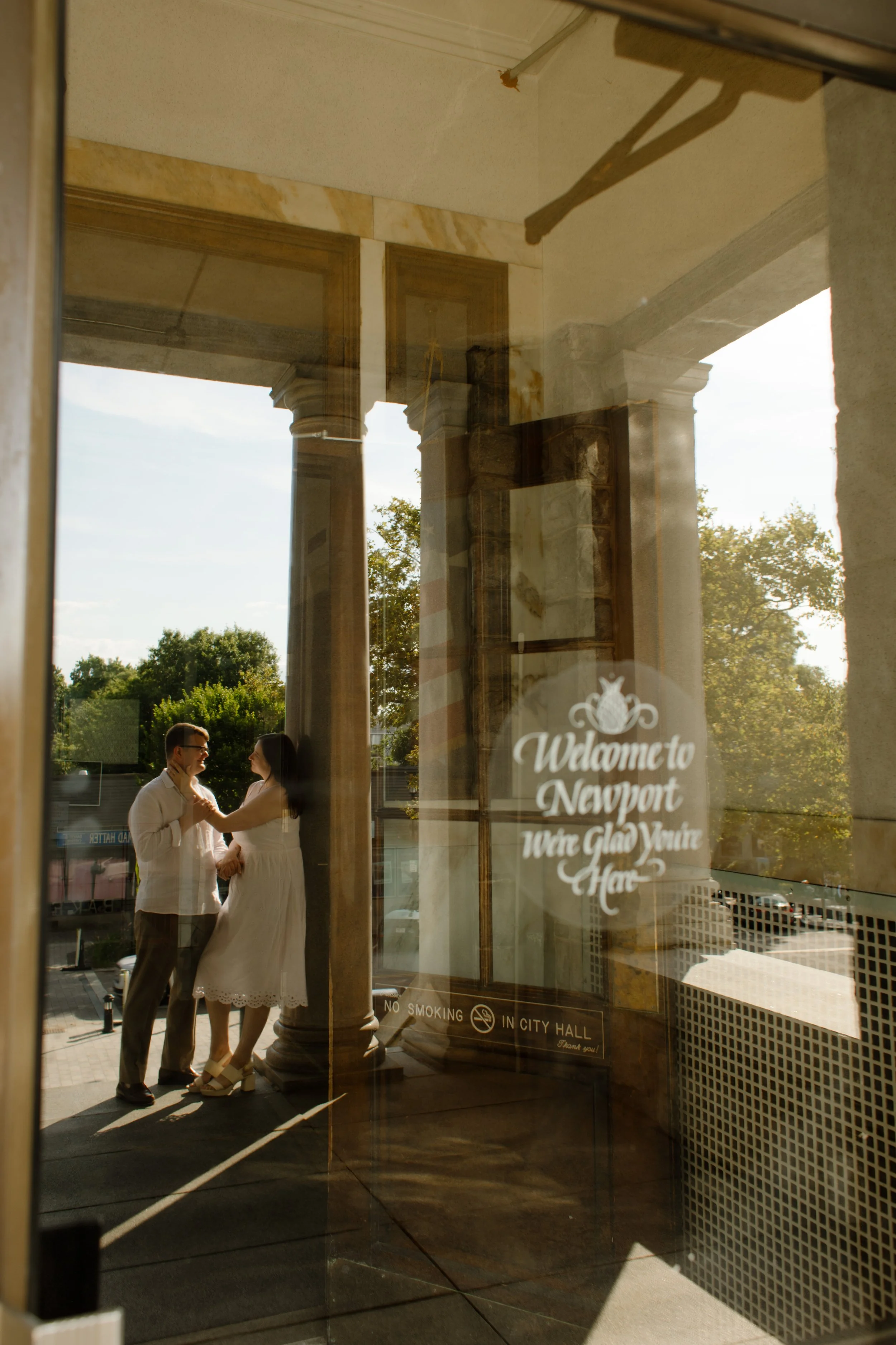 Couple standing inside Newport City Hall entrance during Newport Rhode Island engagement photos