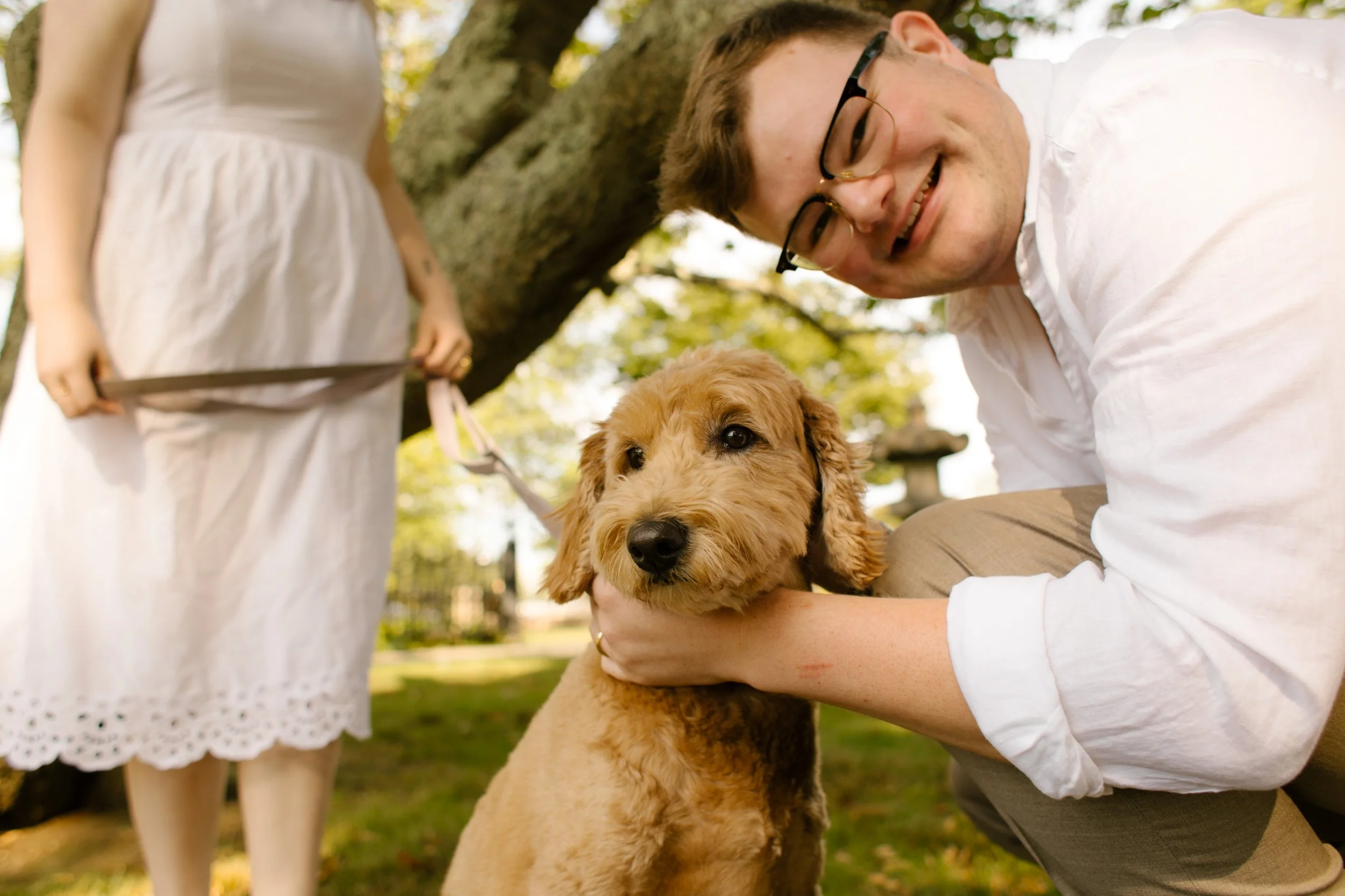Couple with their dog during Newport Rhode Island engagement photos in park