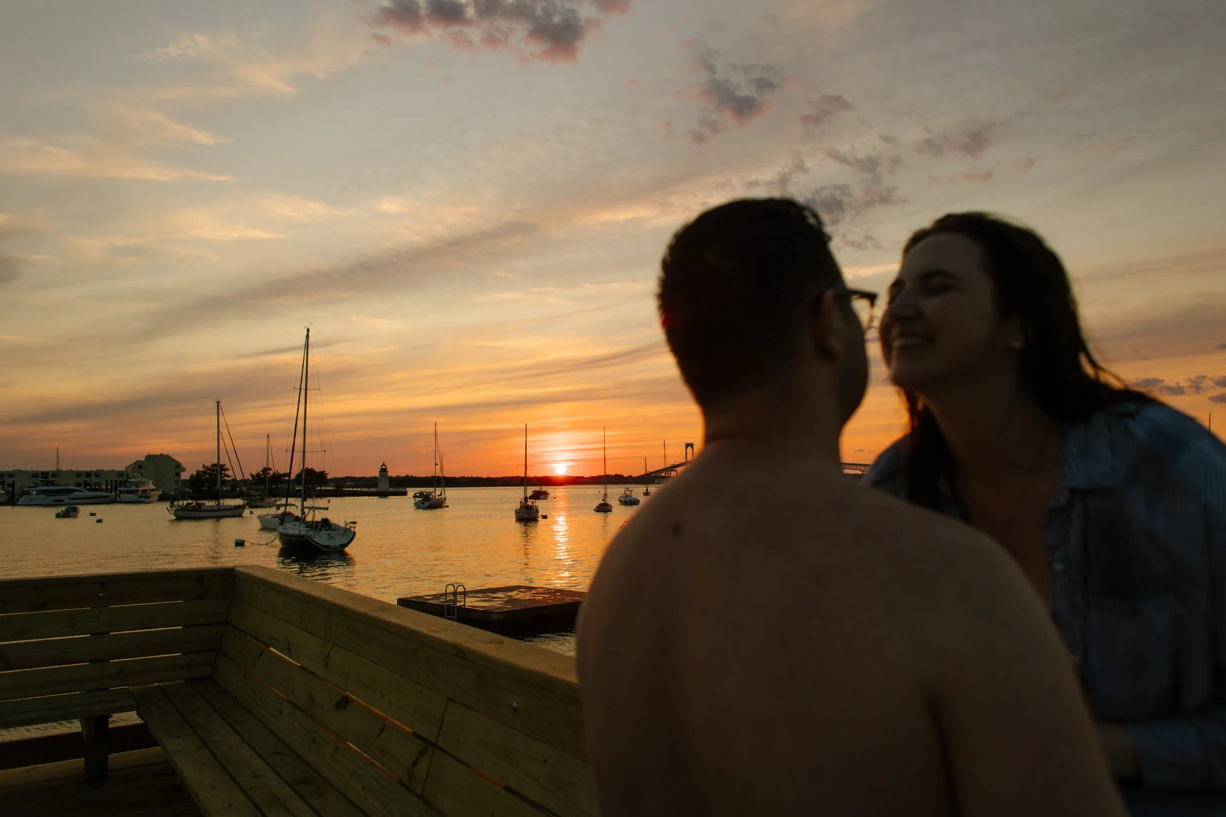 Romantic sunset moment on Newport harbor dock during Newport Rhode Island engagement photos