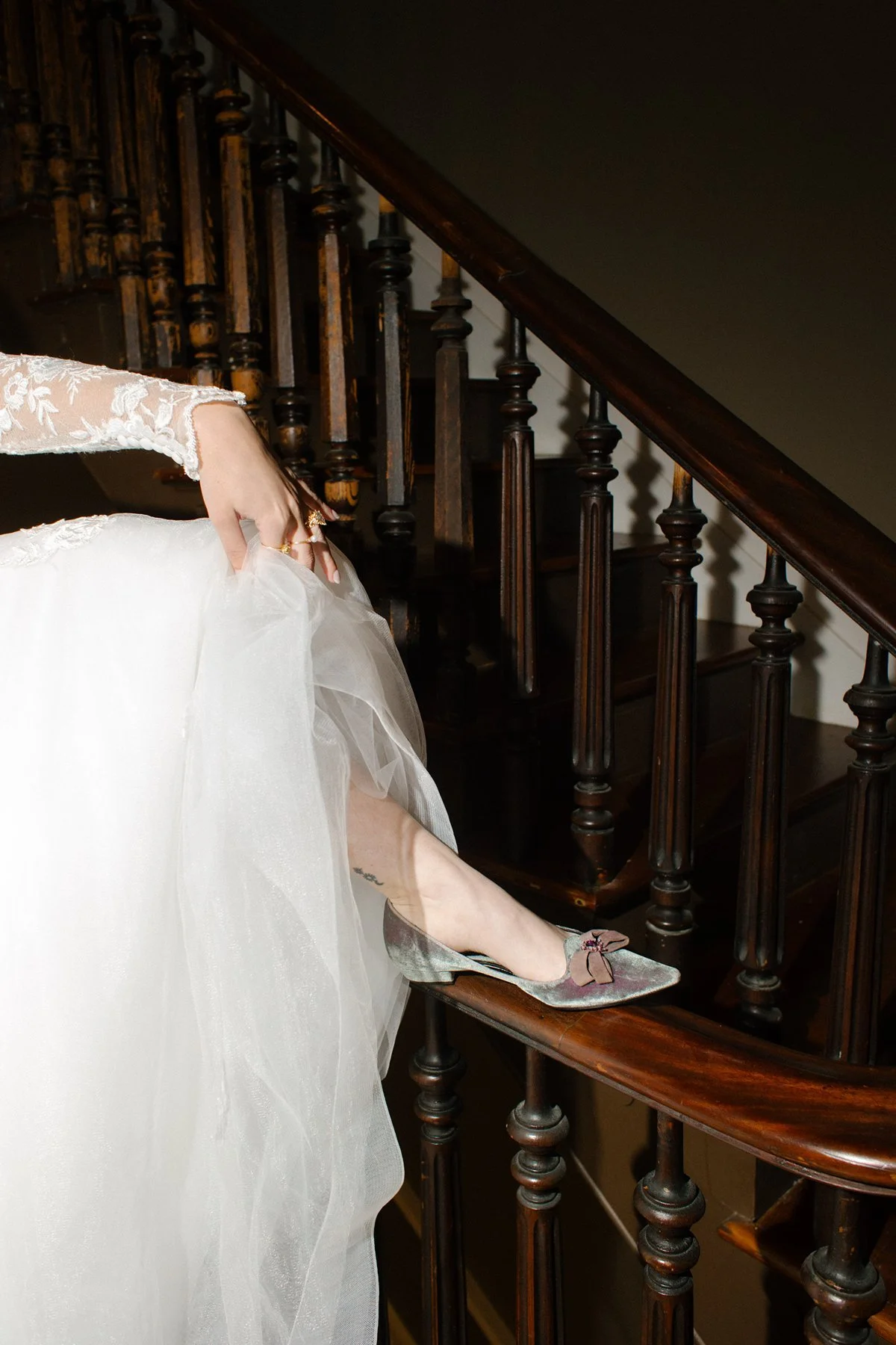 bride stepping into velvet heels on staircase, elegant and editorial bridal detail moment
