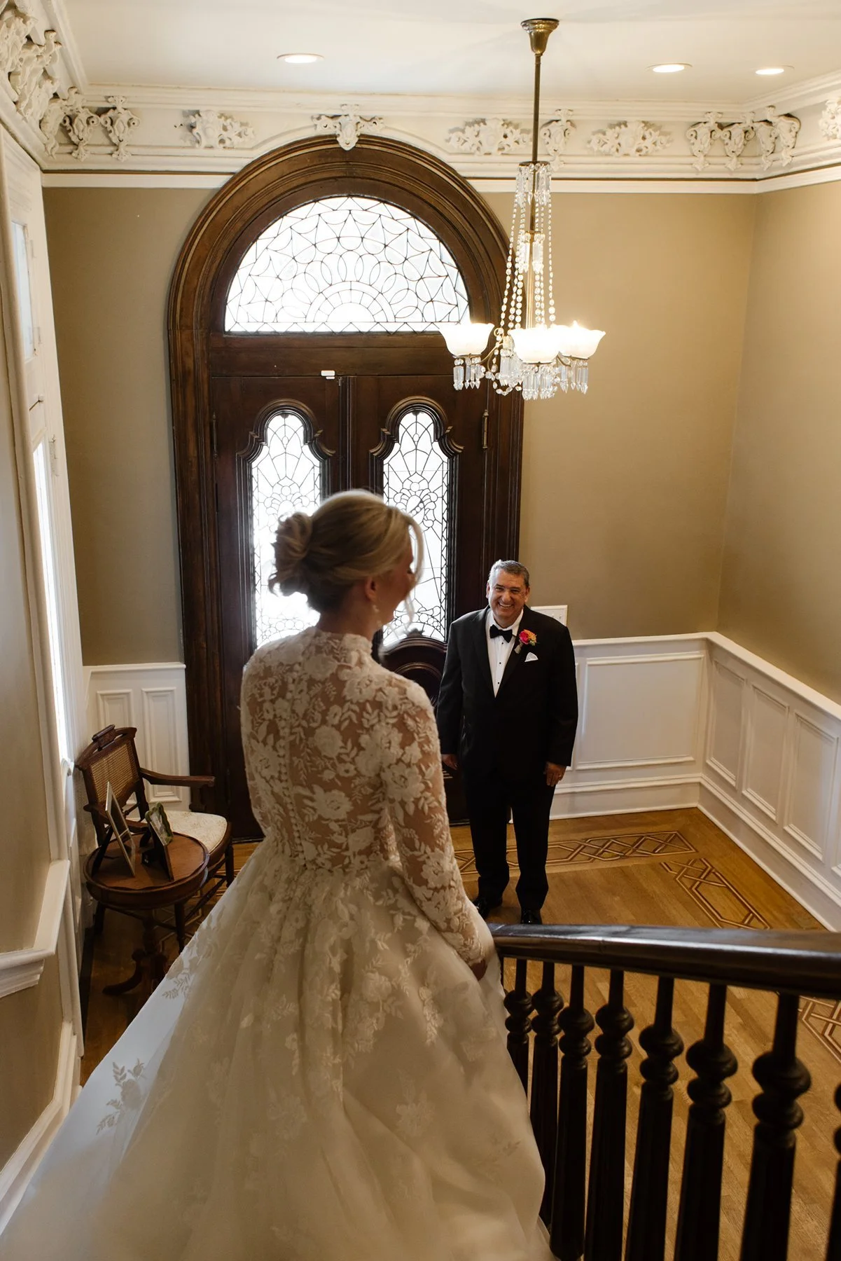bride seeing father for first time at bottom of staircase, emotional first look moment inside historic memphis home