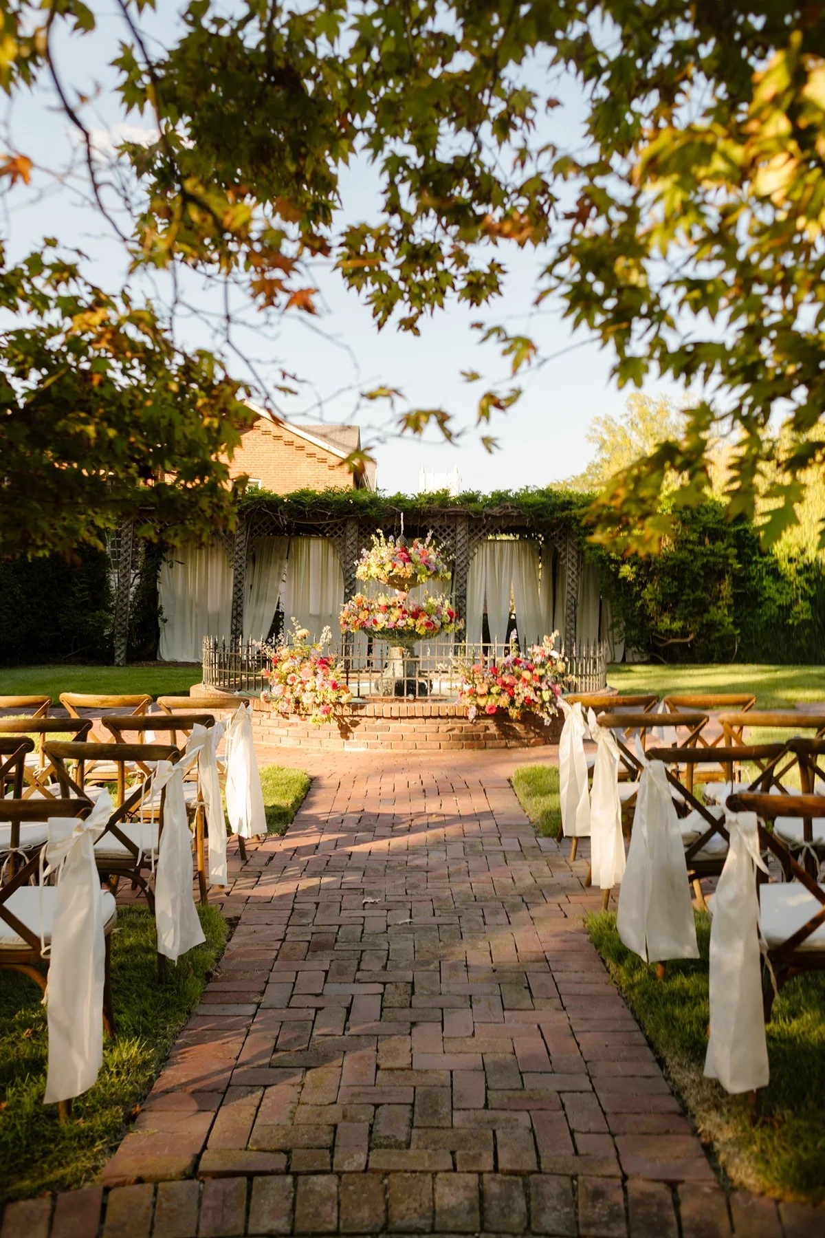 bride standing by window in soft natural light, quiet reflective moment before ceremony inside a memphis wedding venue