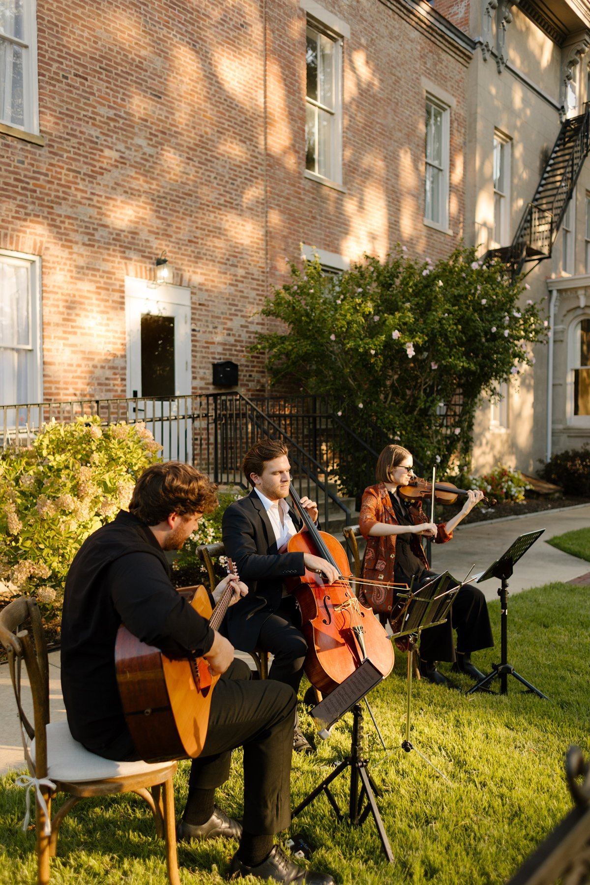 outdoor ceremony setup with floral-covered fountain and brick aisle framed by greenery at a memphis wedding venue