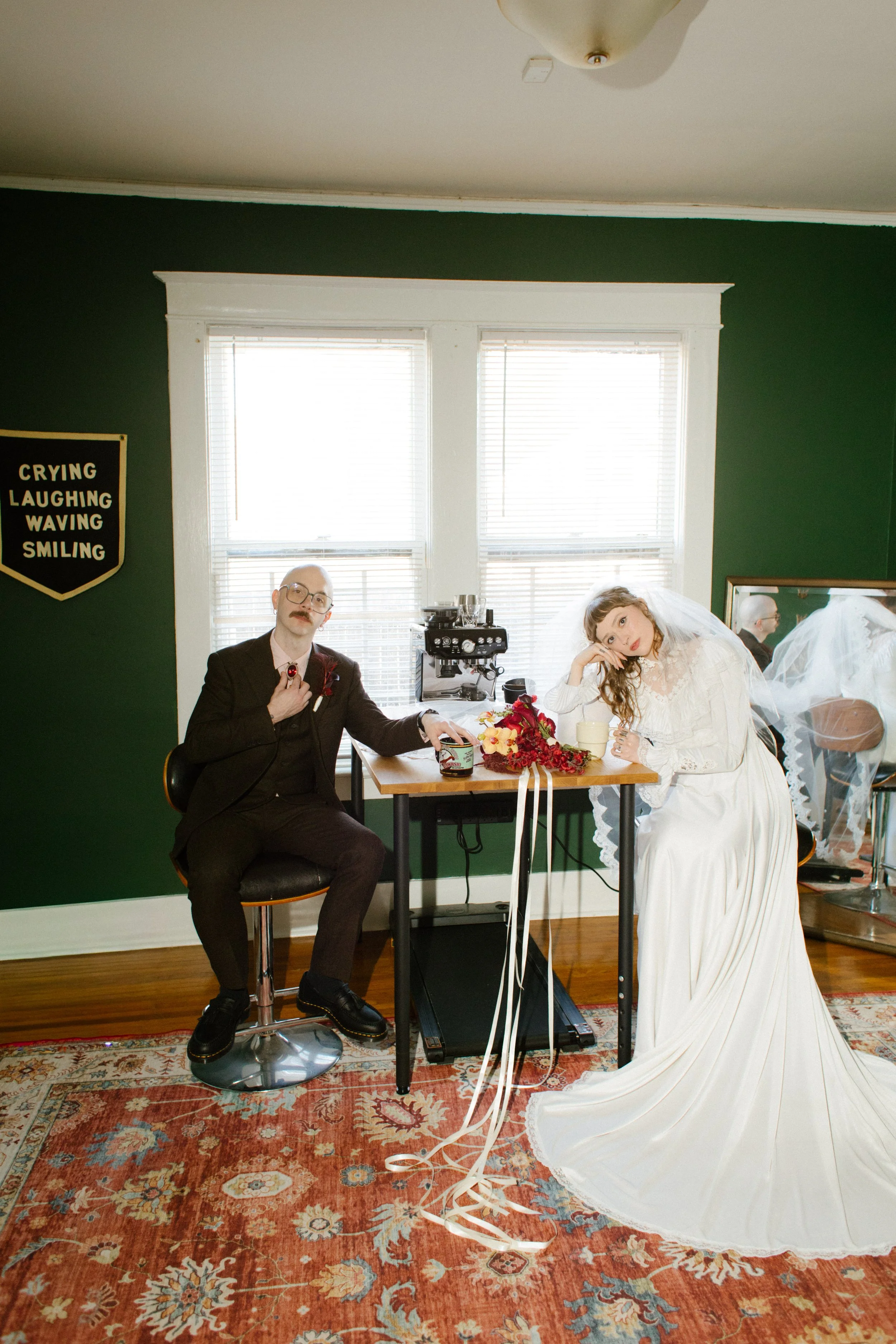 Bride and groom sitting at a table in their home during wedding morning, highlighting relaxed and personal unique wedding ideas