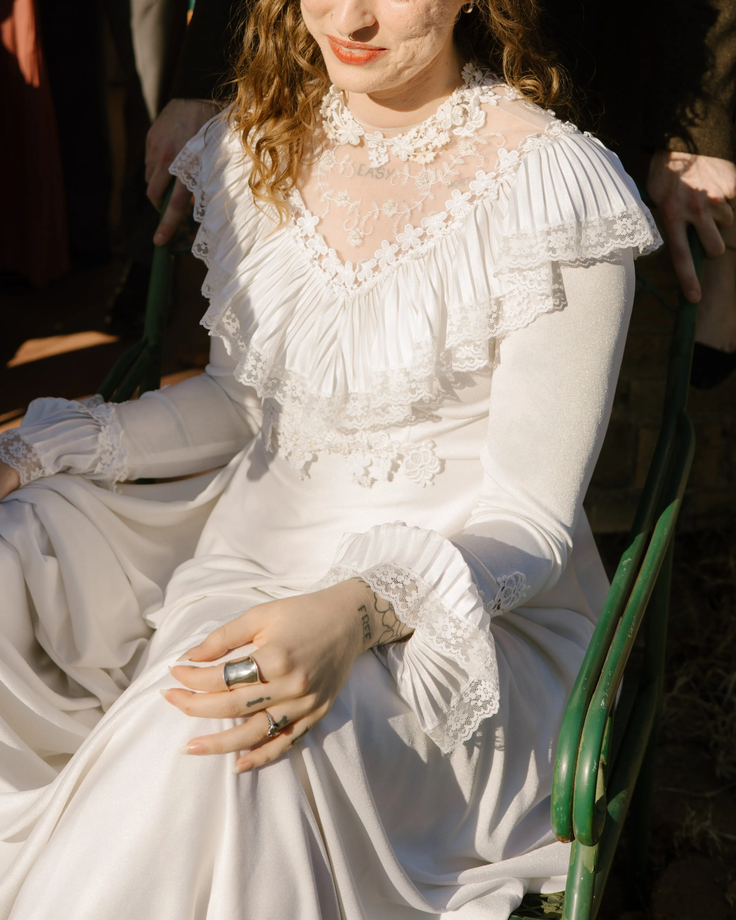 Close-up of bride’s lace wedding dress and delicate details in natural light, capturing timeless bridal styling