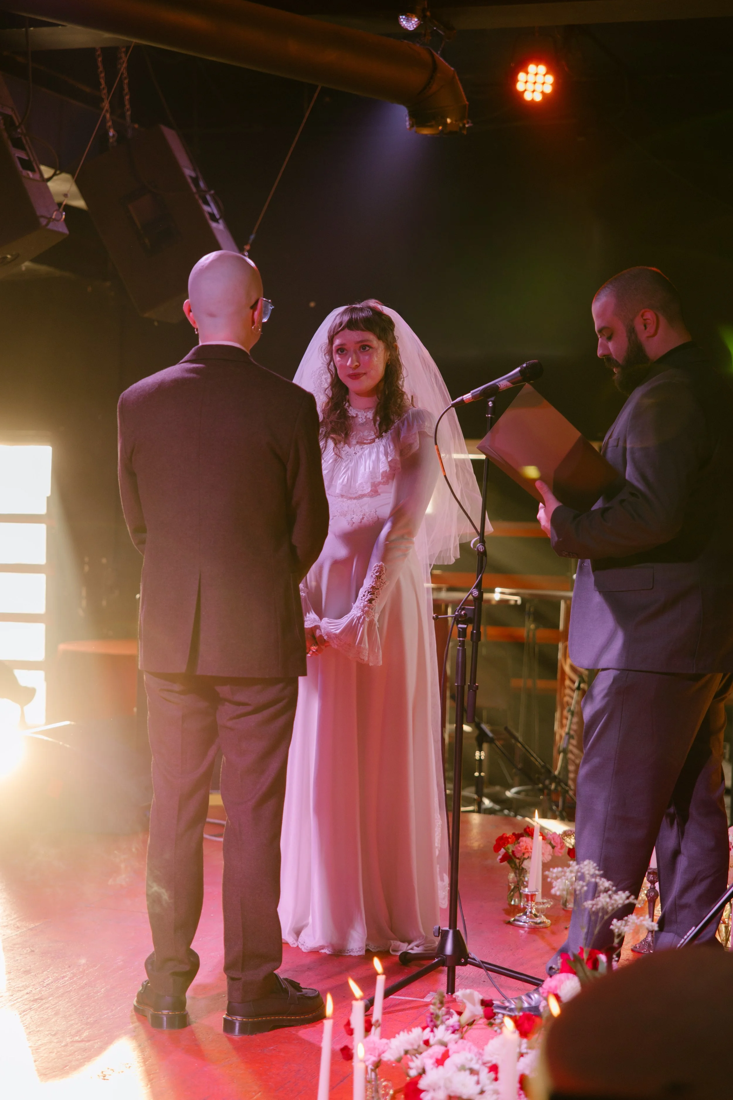 Bride and groom standing together during ceremony at Hi Tone venue with warm lighting and intimate atmosphere