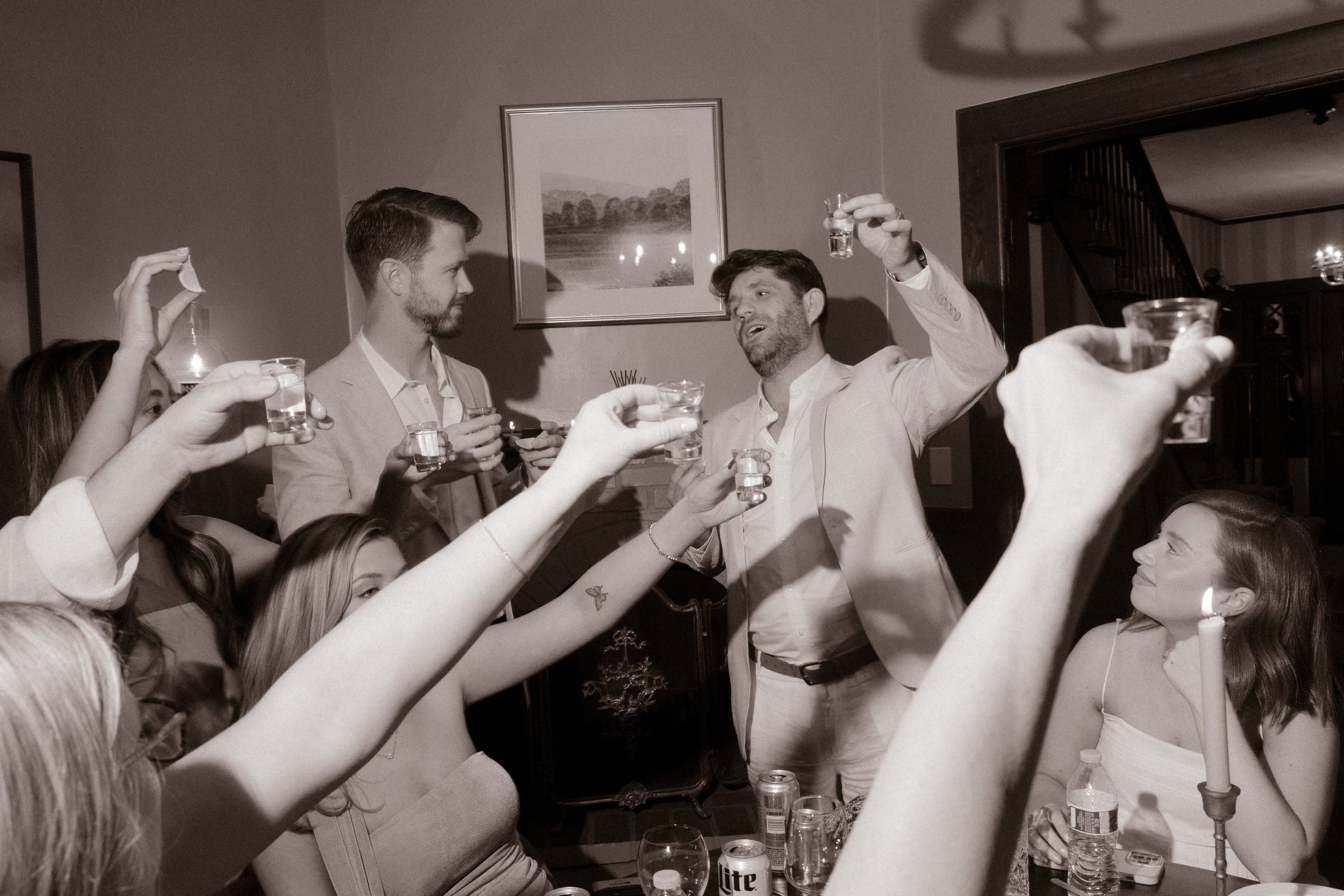 Guests raising tequila shots together in a celebratory toast during a wedding in Santa Barbara