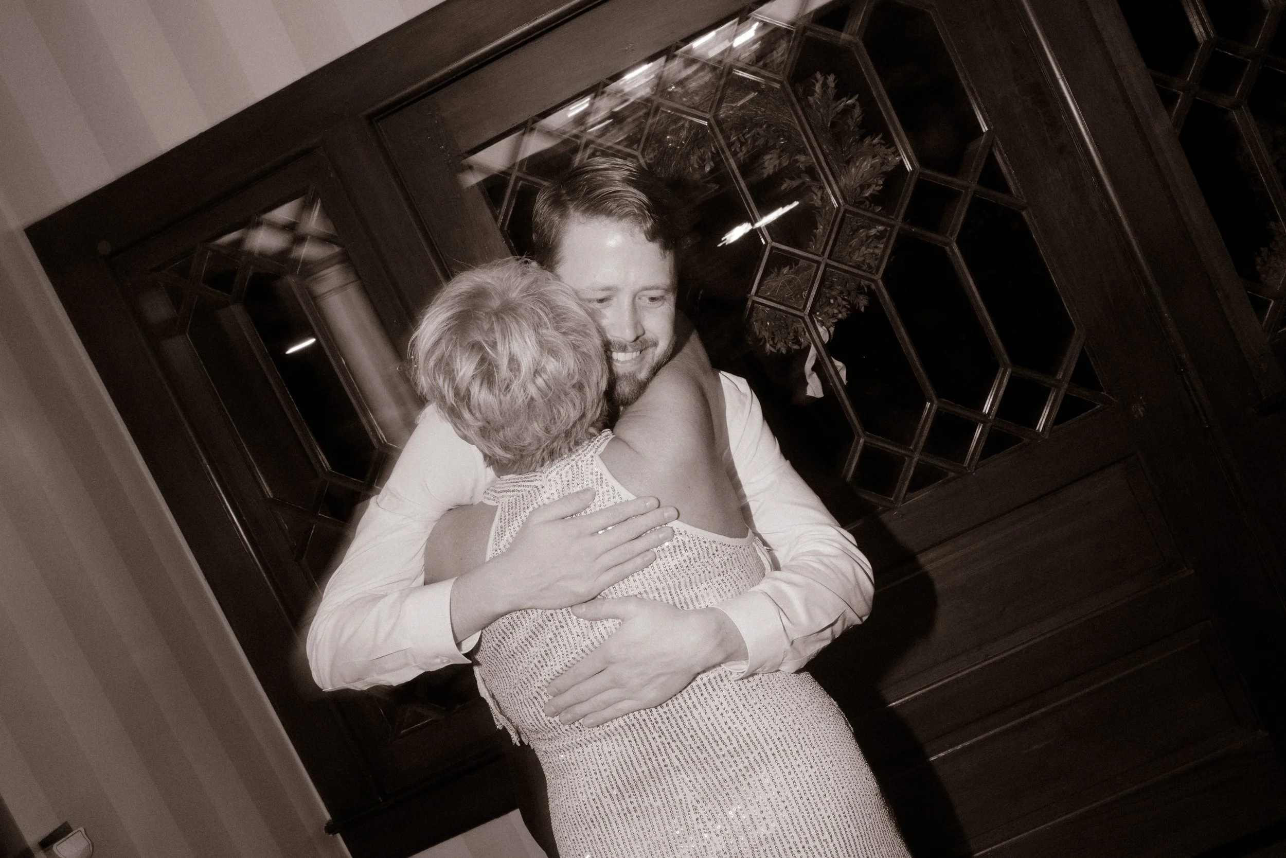 Emotional embrace between guests captured in black and white during a wedding in Santa Barbara