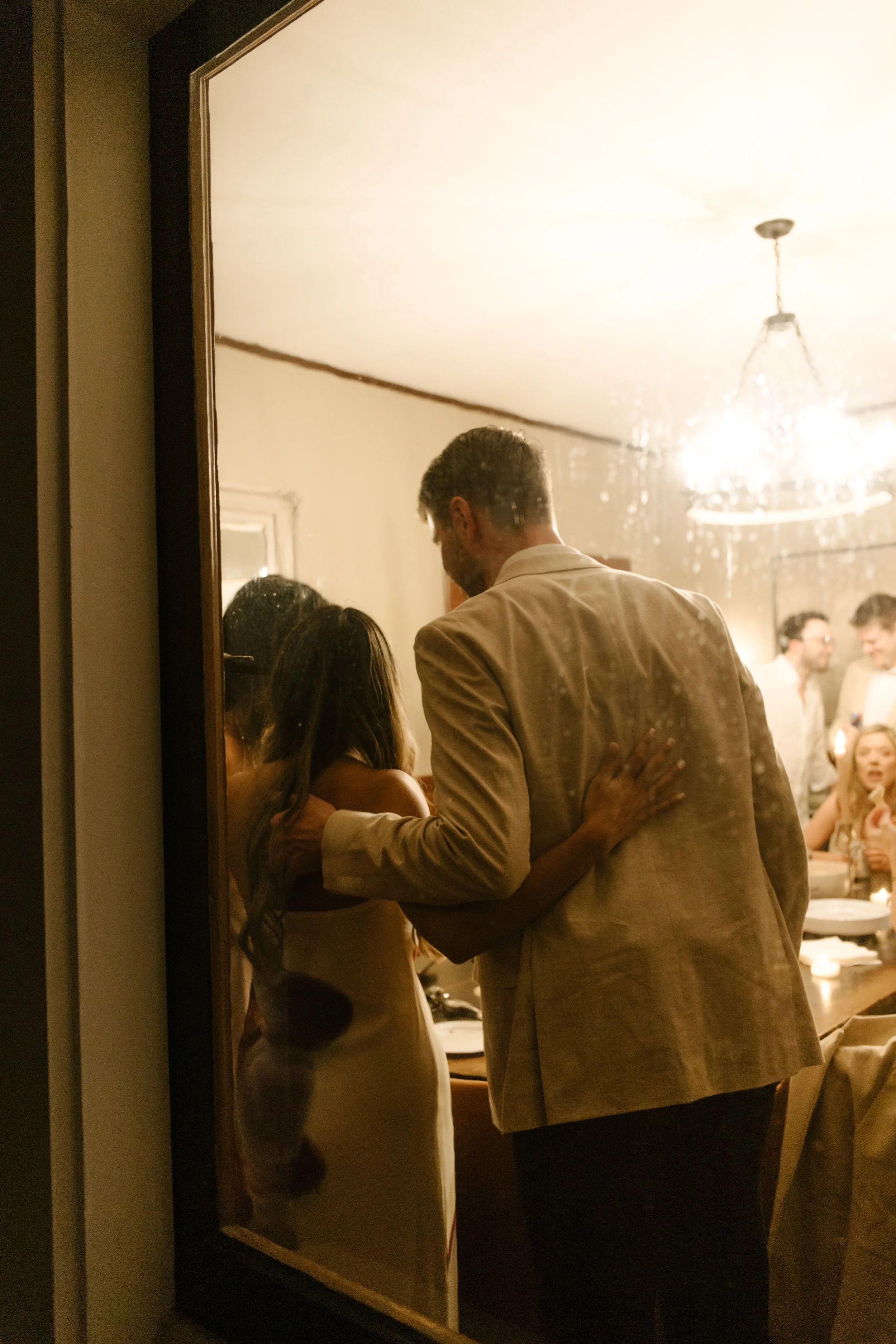 Couple walking into a candlelit dinner scene together during a wedding in Santa Barbara