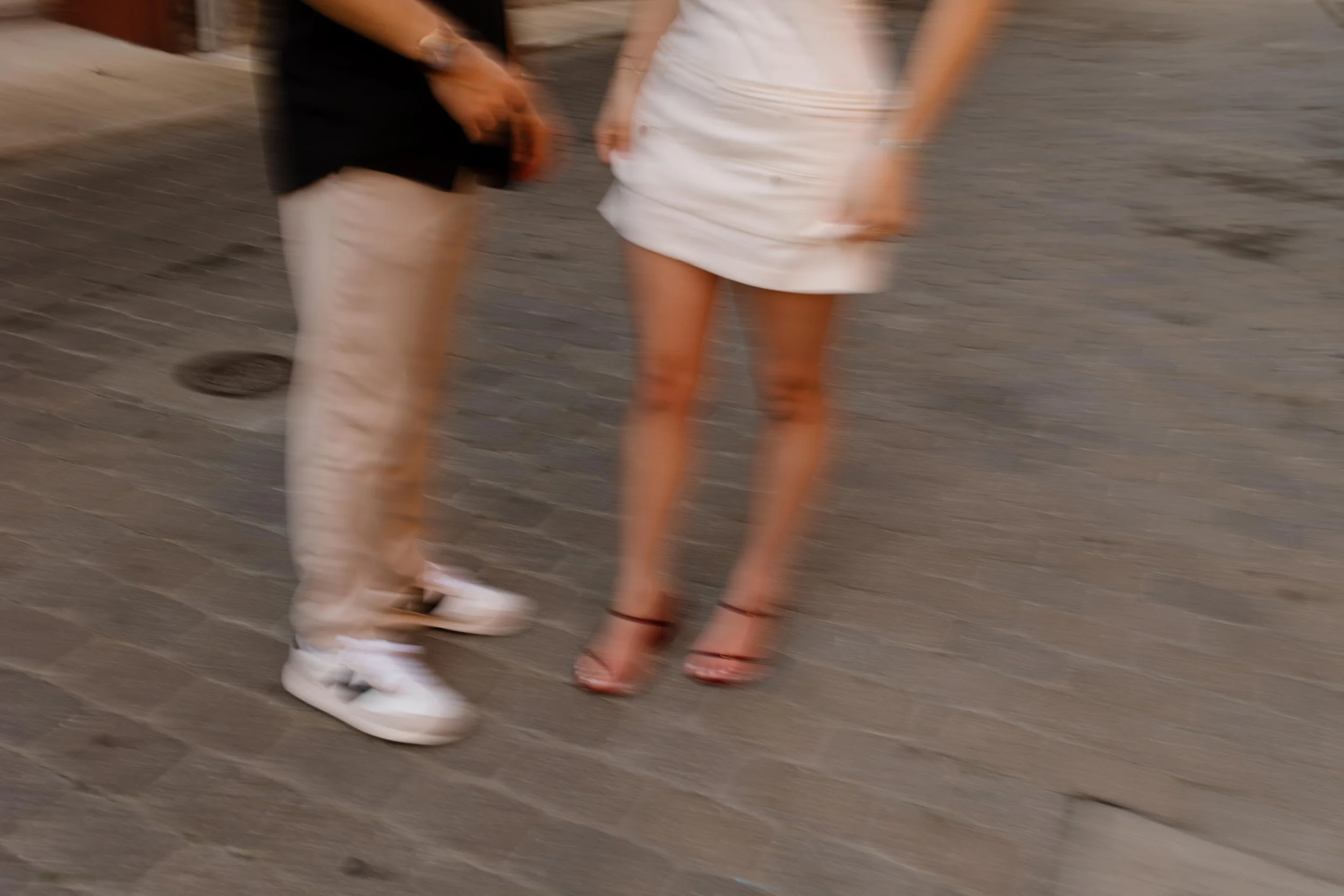 Blurred movement shot of couple standing together on a downtown street during new york city engagement photos