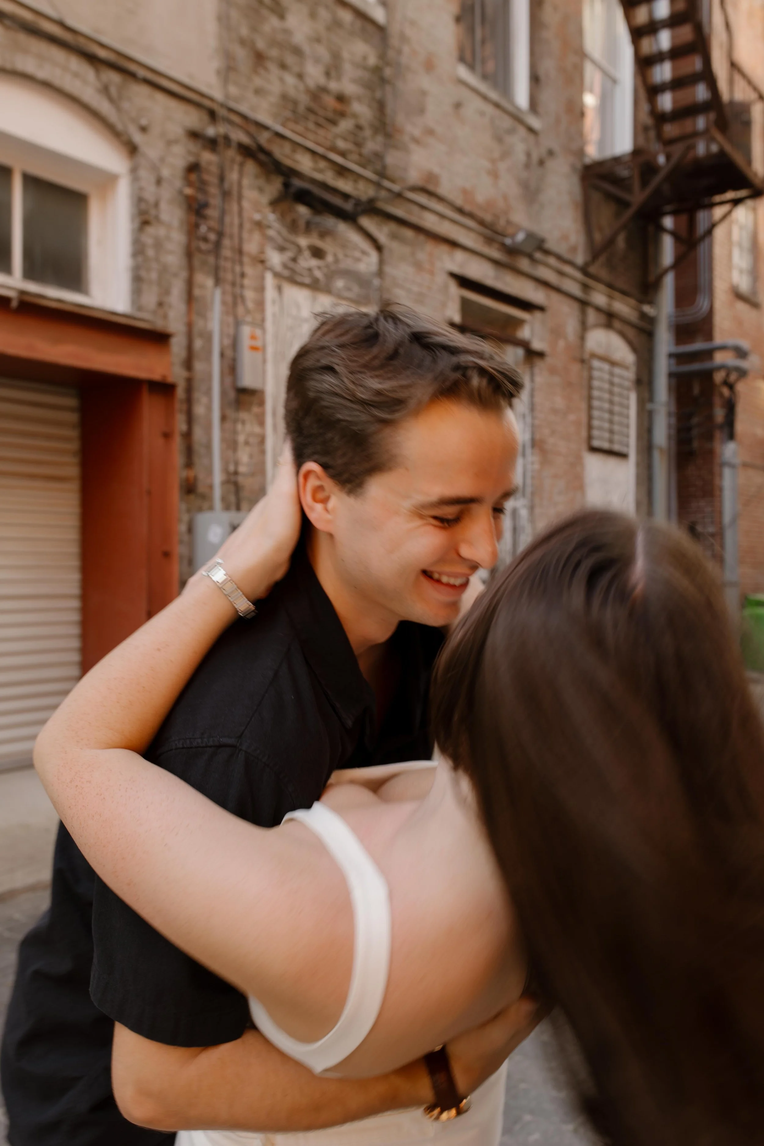 Close up of couple laughing and leaning into each other during new york city engagement photos with a candid feel