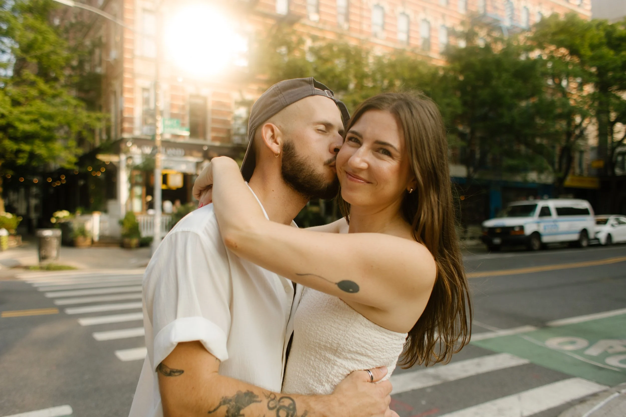 New York engagement photographer photographing a couple embracing on a quiet city street at golden hour.