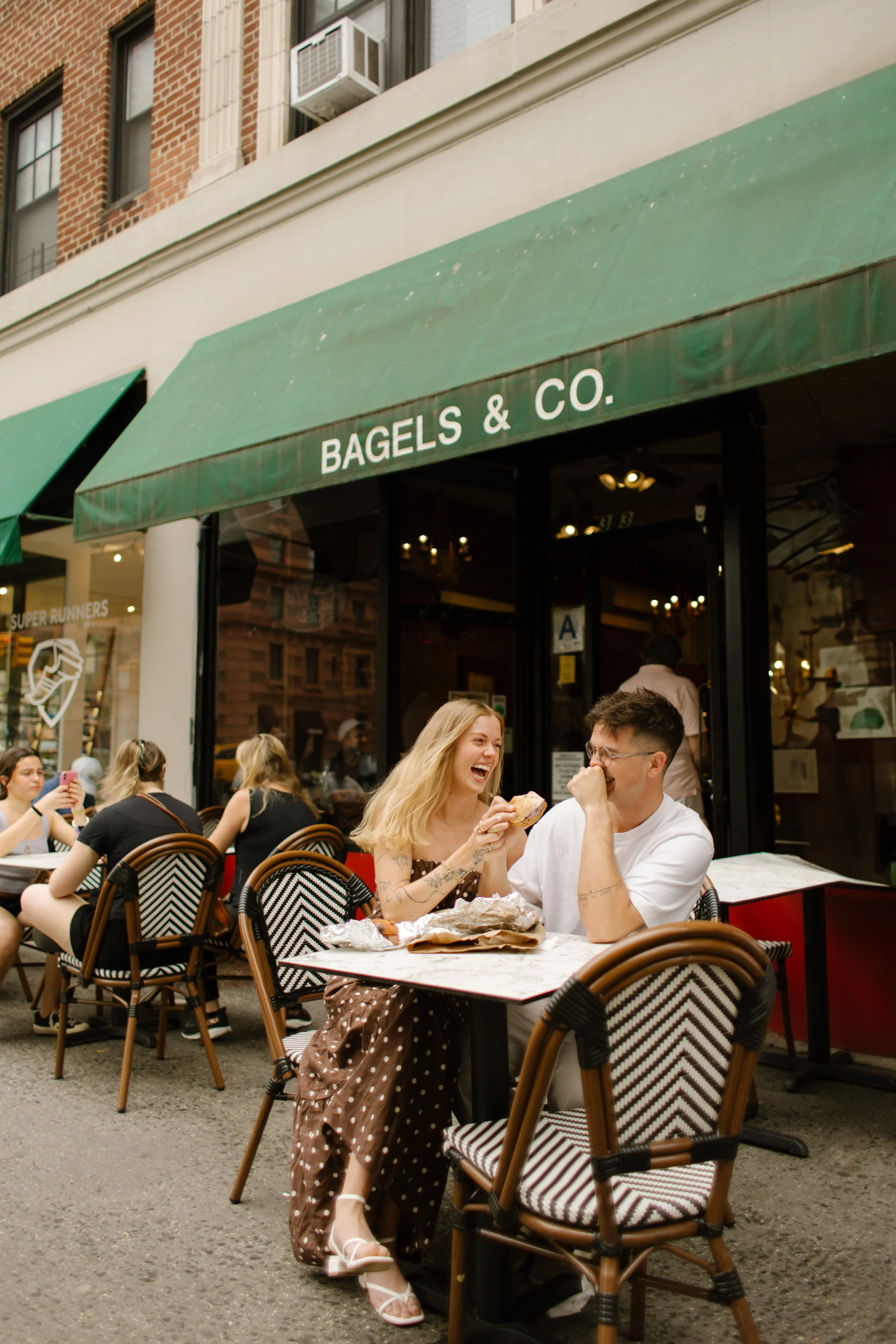 New York engagement photographer capturing a couple eating pizza together inside a classic New York pizzeria.