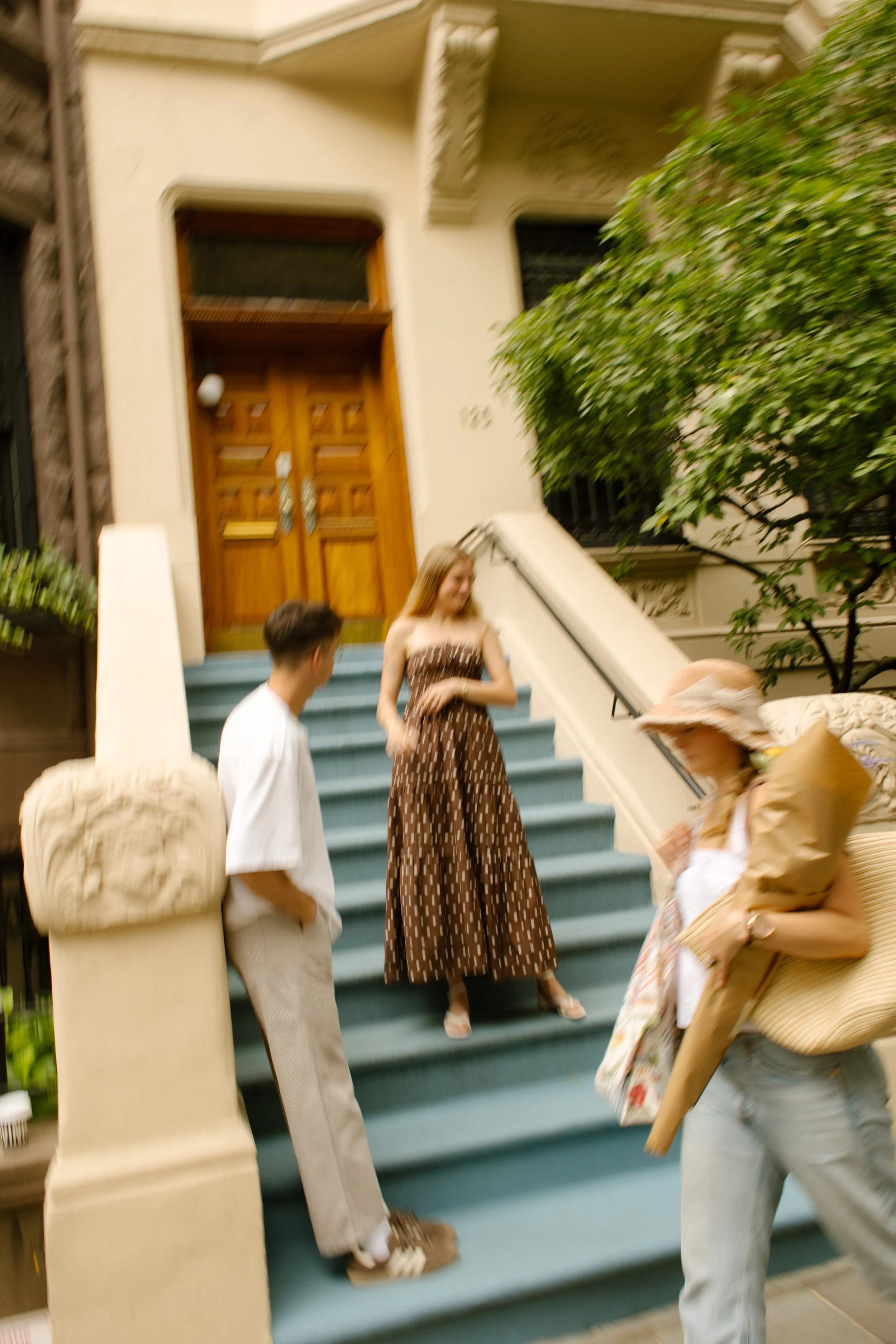 New York engagement photographer documenting a candid moment outside a Brooklyn brownstone with motion blur and editorial styling.