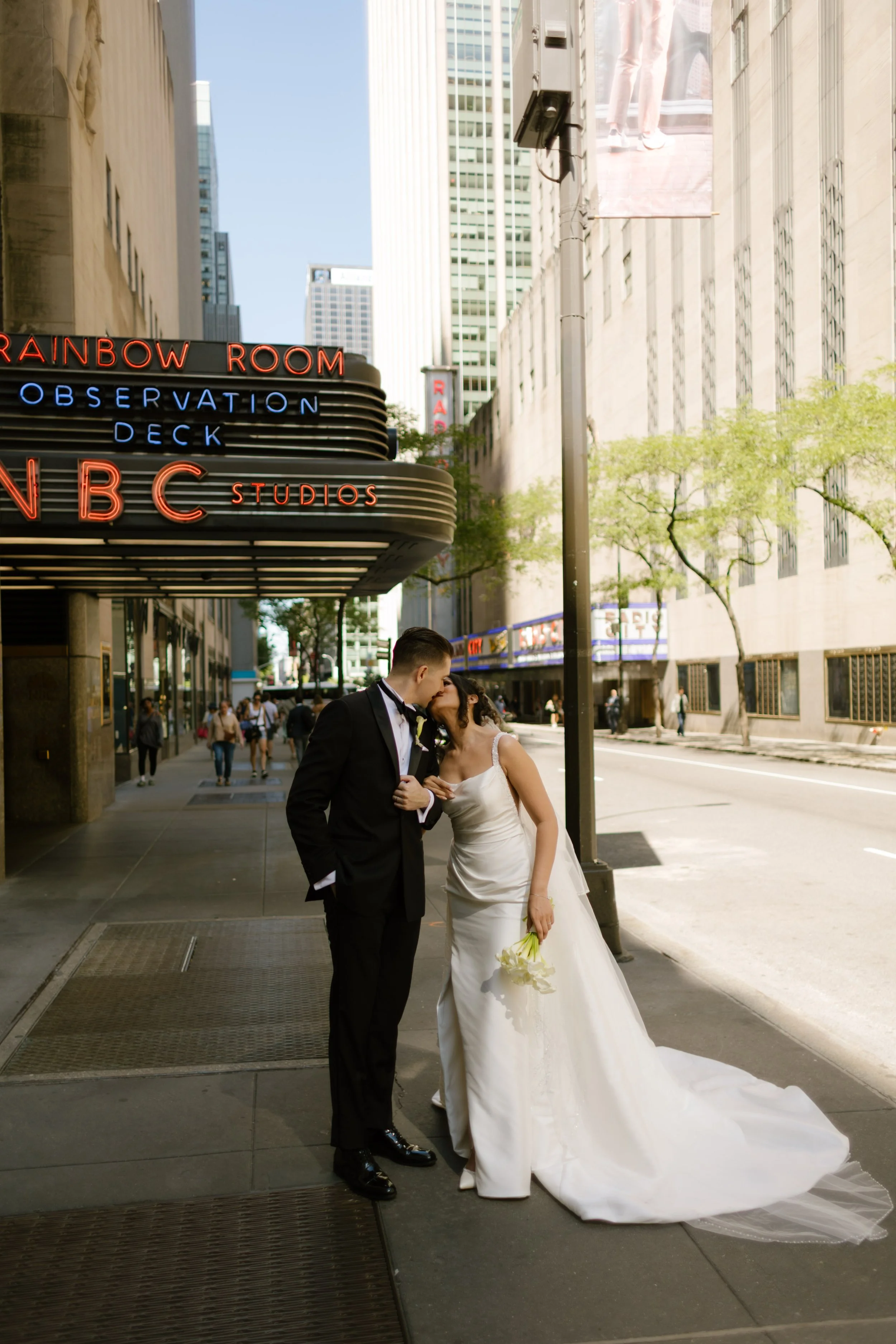 Bride and groom walking through quiet cobblestone SoHo street during New York Wedding portraits