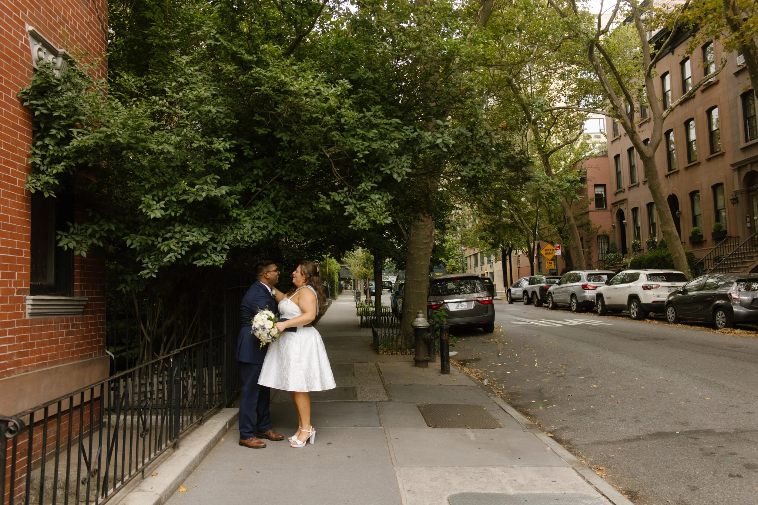 Intimate portrait of newlyweds embracing on peaceful Brooklyn brownstone street
