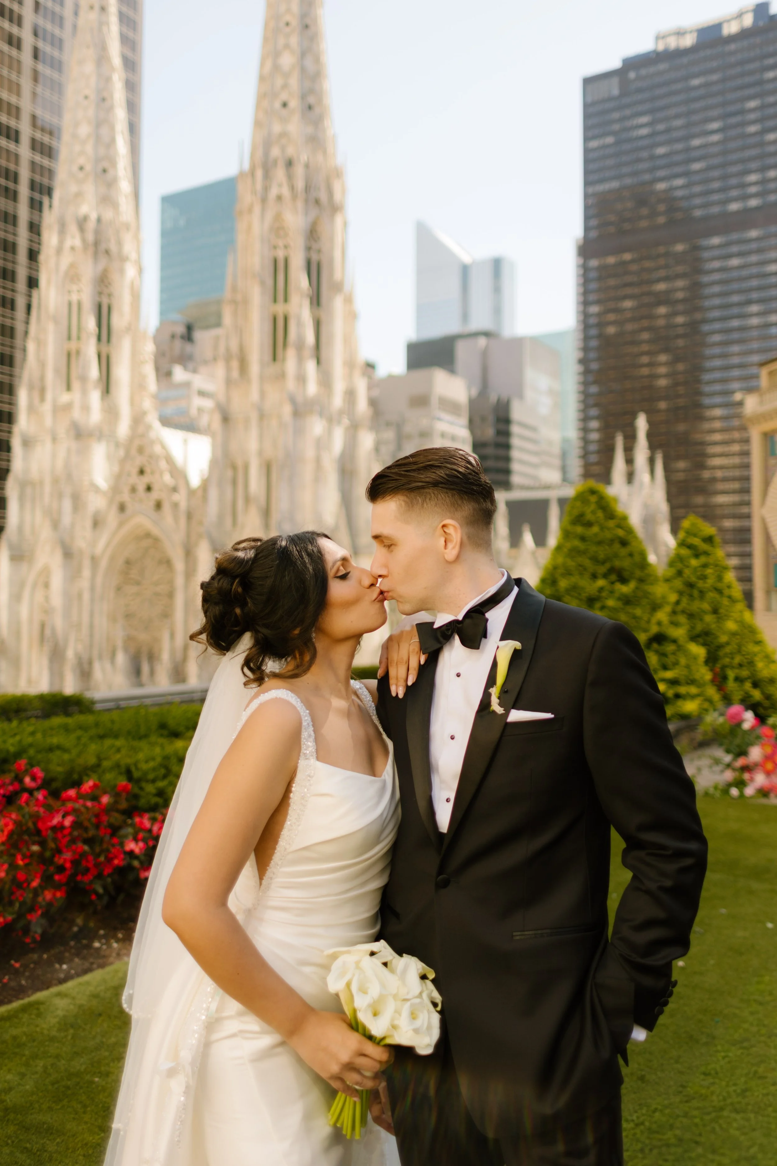 Bride and groom kissing during rooftop New York Wedding portraits beside St. Patrick’s Cathedral