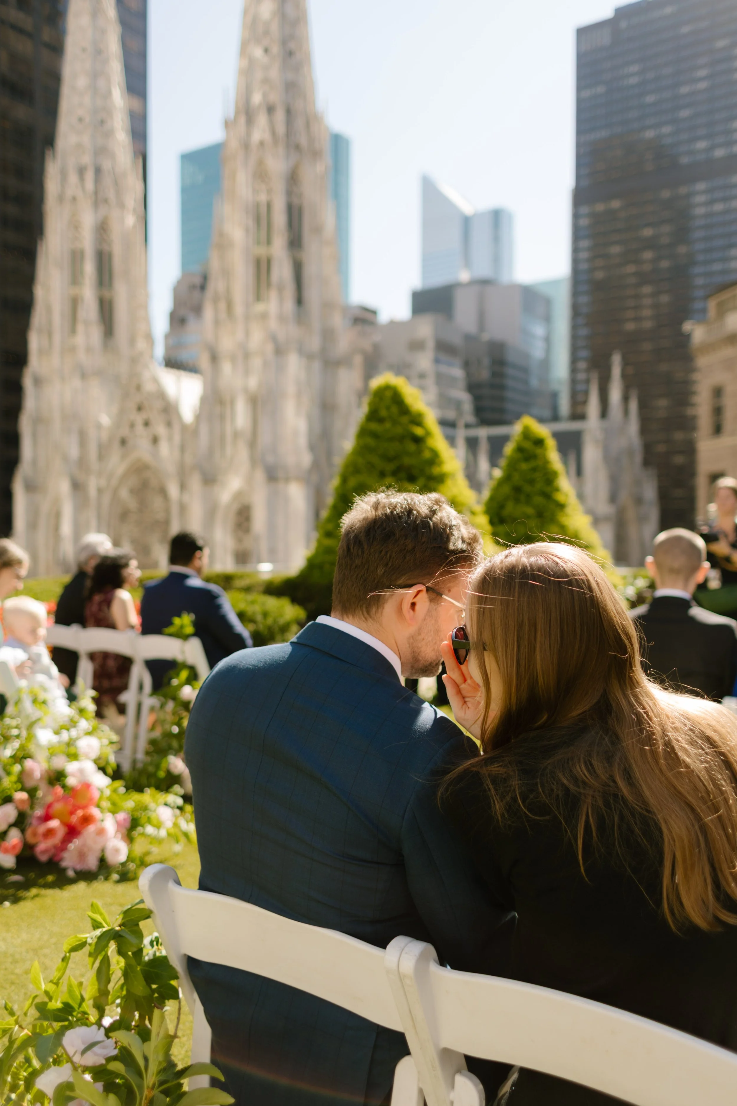 Guests seated at rooftop New York Wedding ceremony with St. Patrick’s Cathedral backdrop