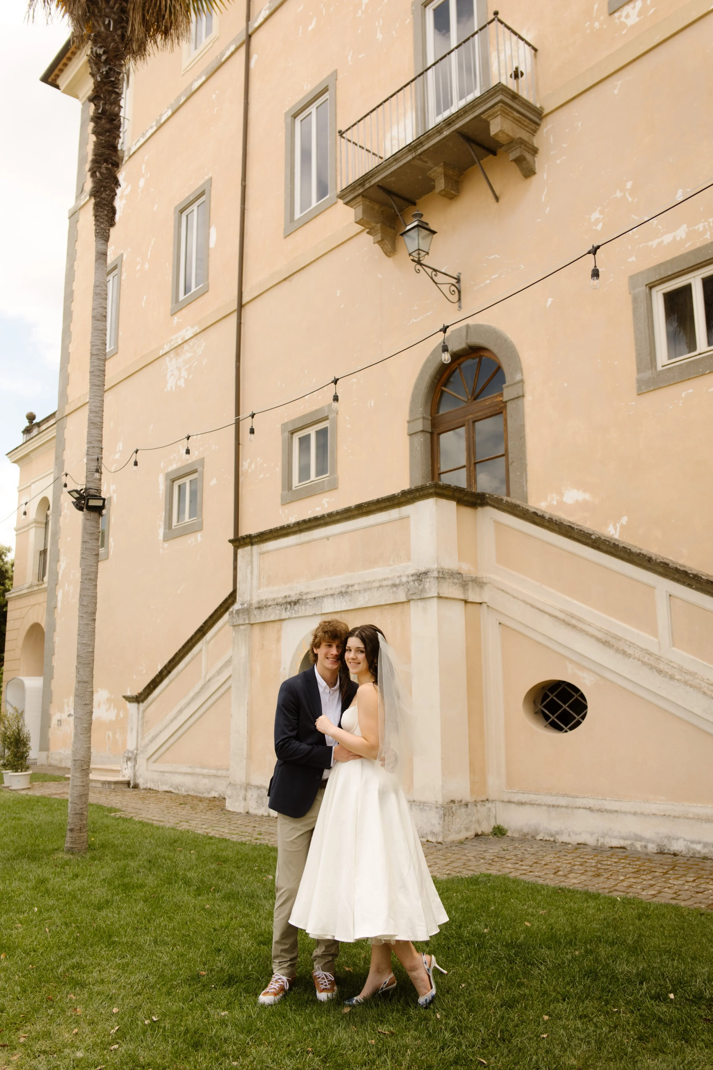 Bride and groom embracing outside a historic Italian villa during a destination wedding in Italy