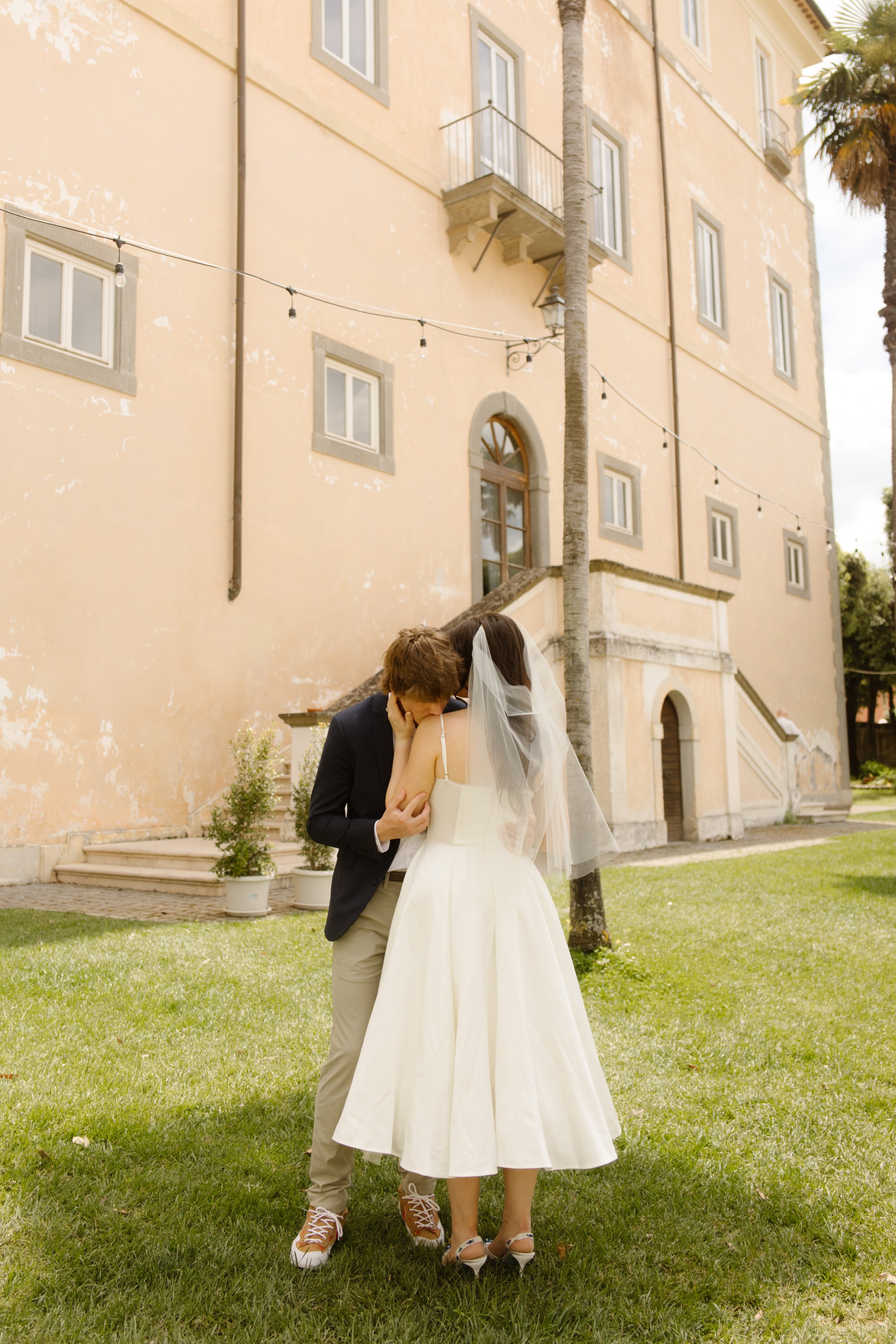 Romantic bride and groom portrait outside an Italian villa during a destination wedding in Italy