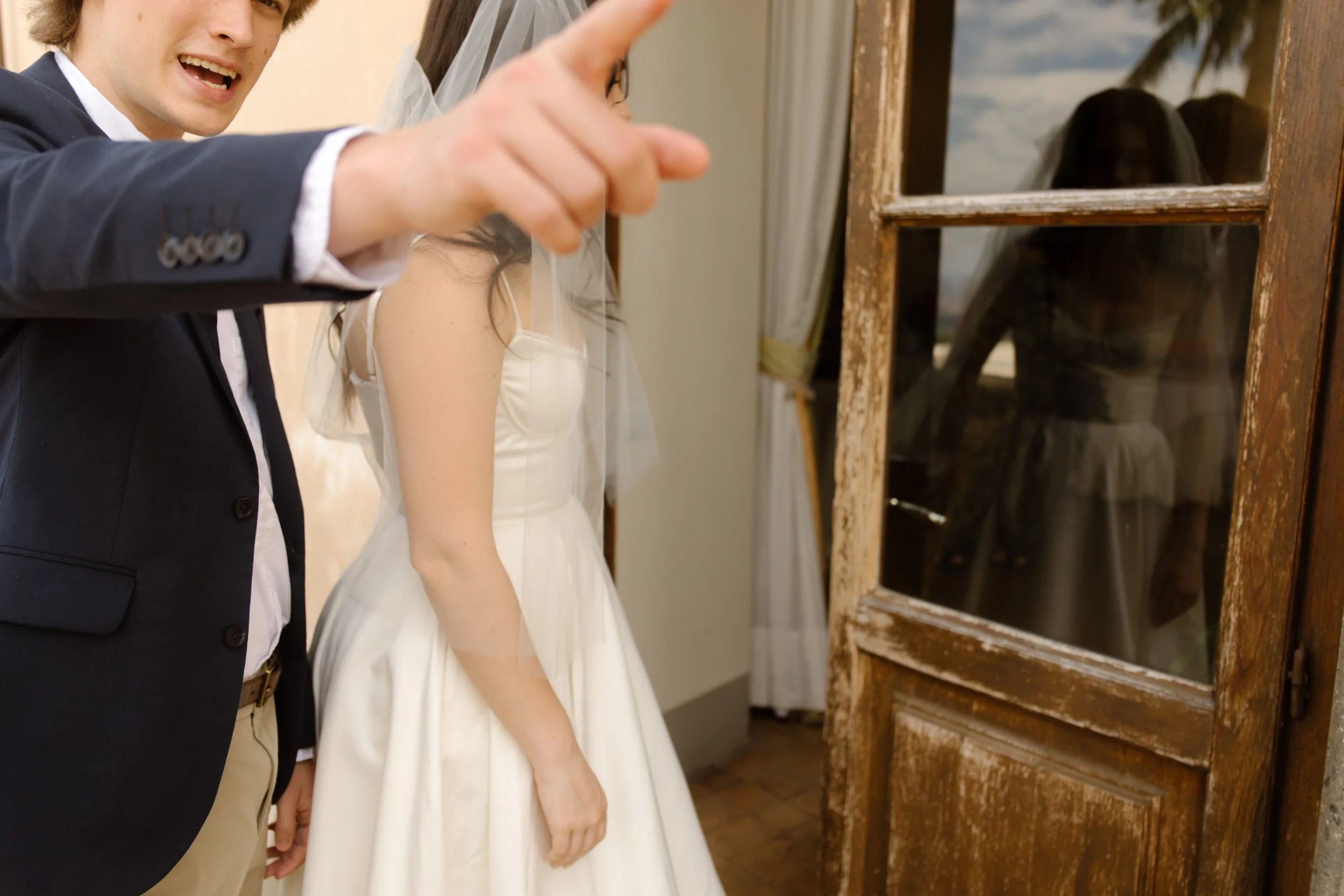 Bride and groom stepping outside a villa during a destination wedding in Italy celebration